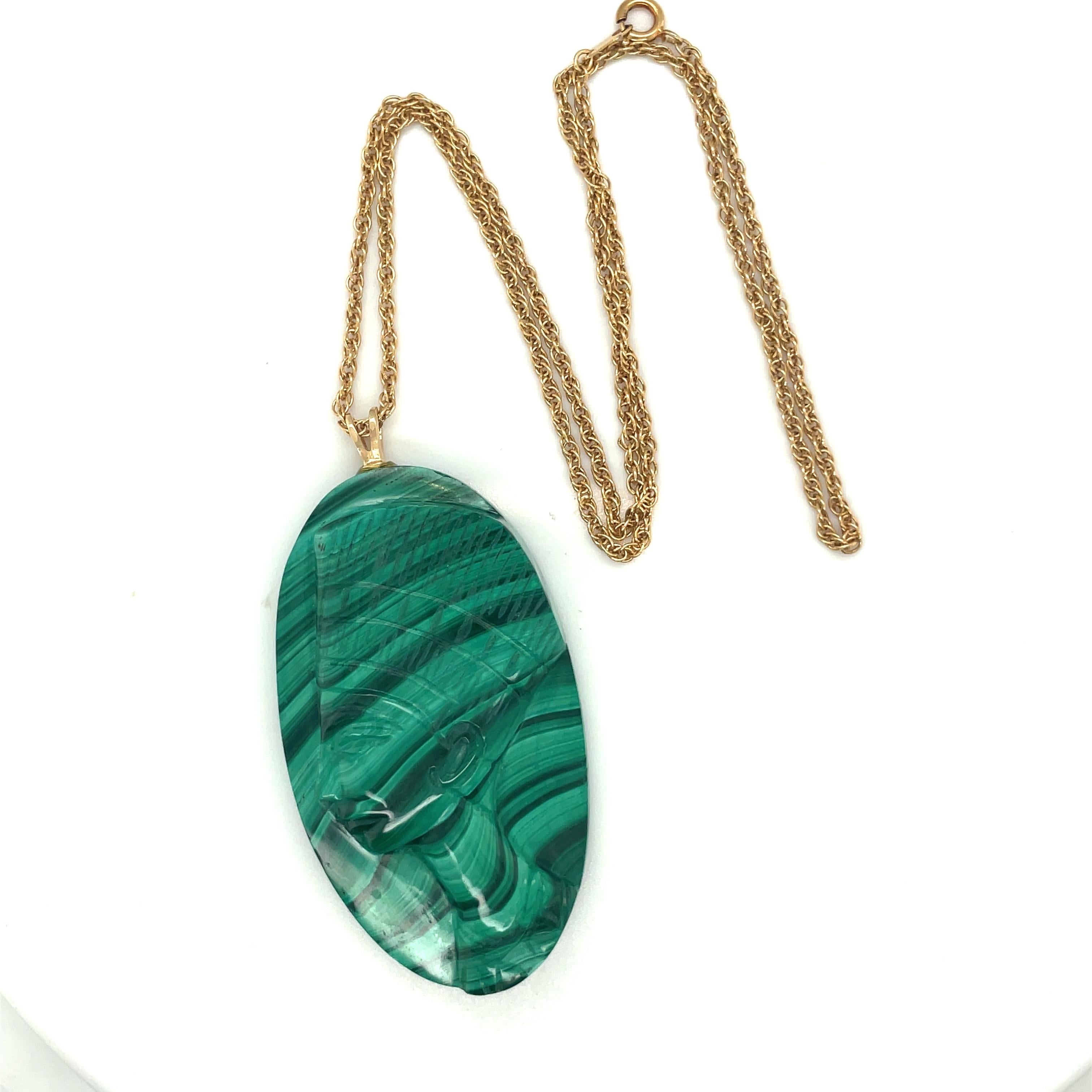Measuring 2 inches long, this stunning carved malachite pendant is sure to strike up conversation. The carving appears to be the profile of an Egyptian ( goddess) and hangs from a 14 karat yellow gold chain measuring 16