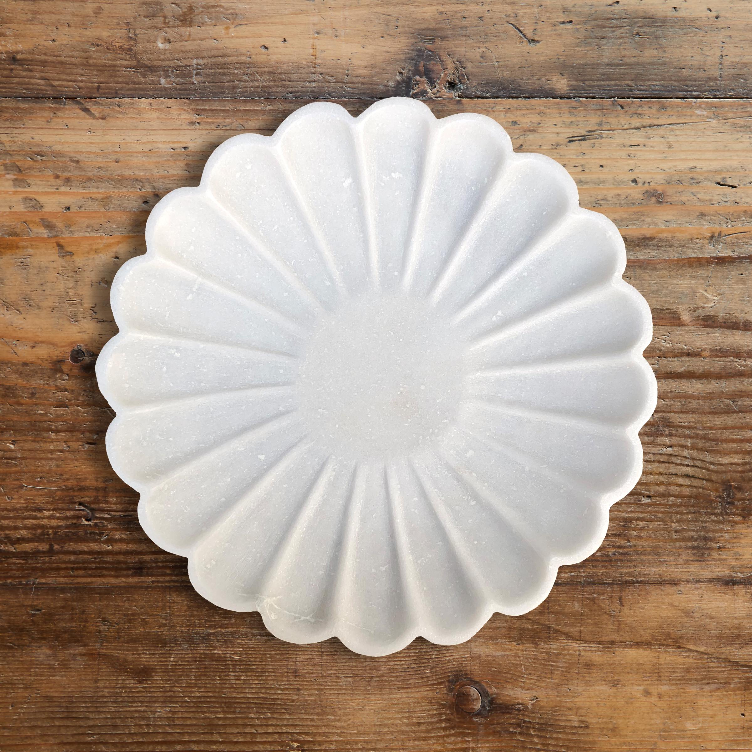 A beautifully carved marble flower form shallow dish. perfect for catching keys, coins, or myriad other things in the kitchen, bathroom, or dressing room.