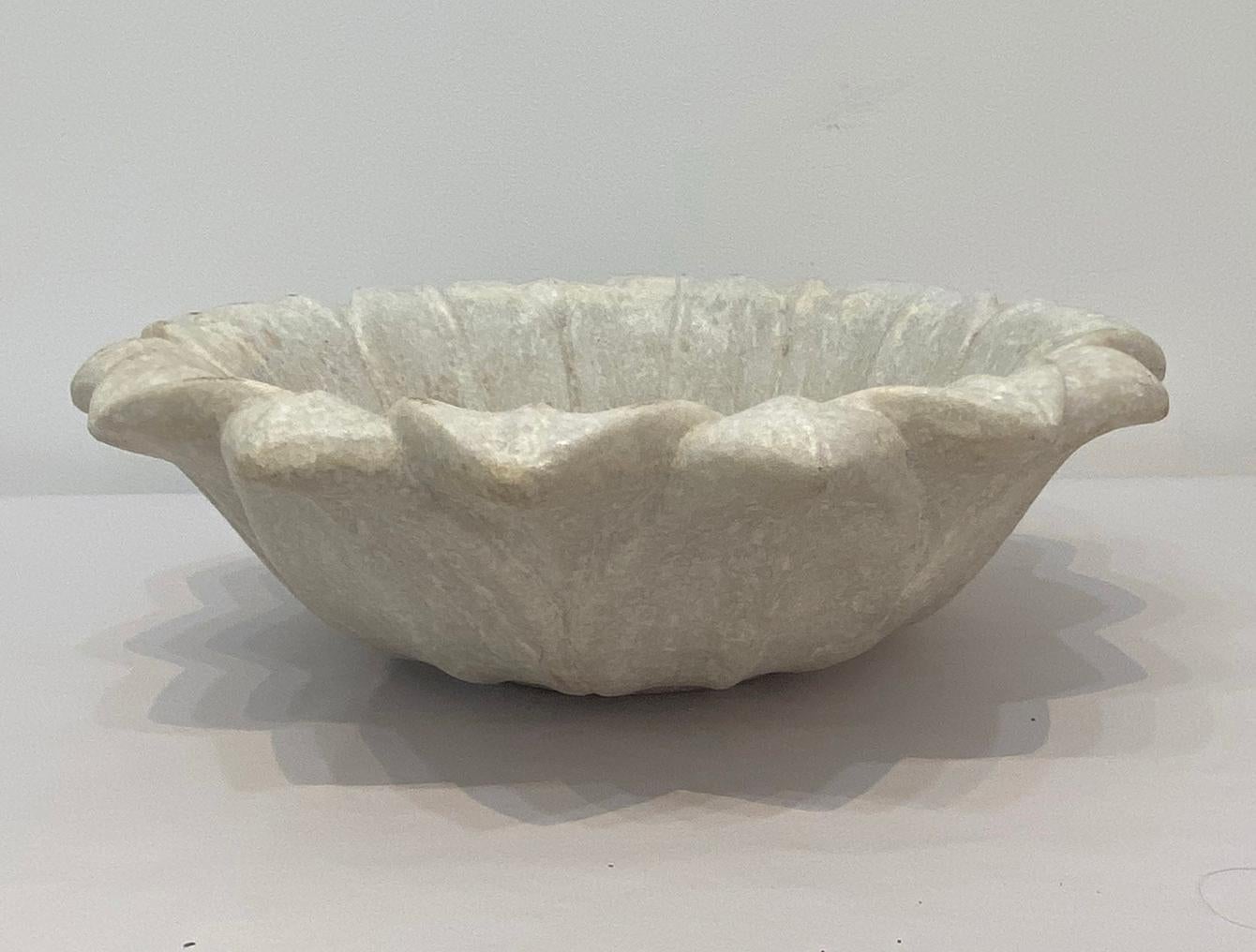 Craved marble lotus bowl with foliate designed rim. Delicately craved beautiful accent piece for your garden.