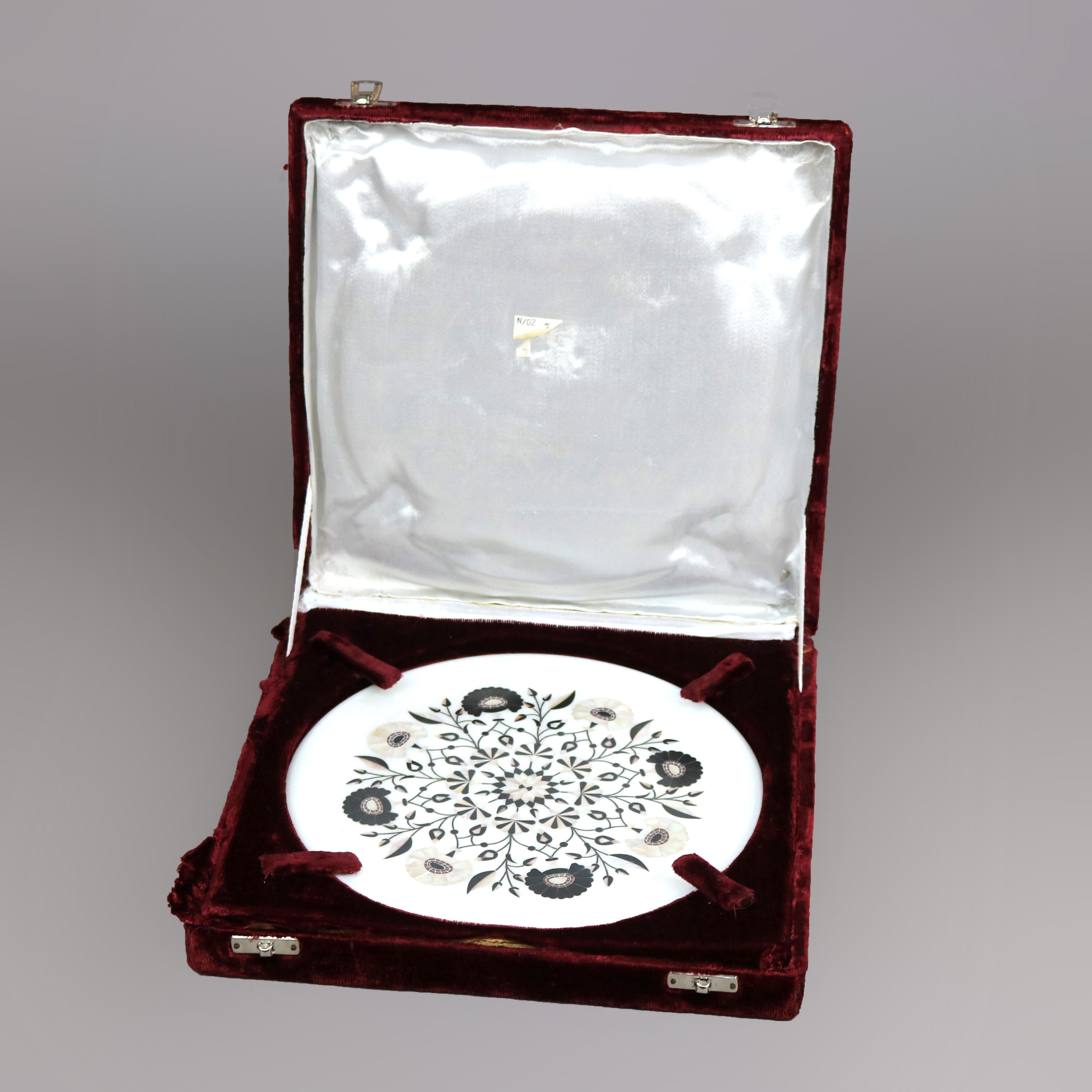 A carved marble presentation plate offers inlaid mother of pearl and ebony stylized floral design, housed in original presenttion box, c1940

Measures - .5''H x 9.25''W x 9.25''D; case 2'' x 11.75'' x 11.75''.