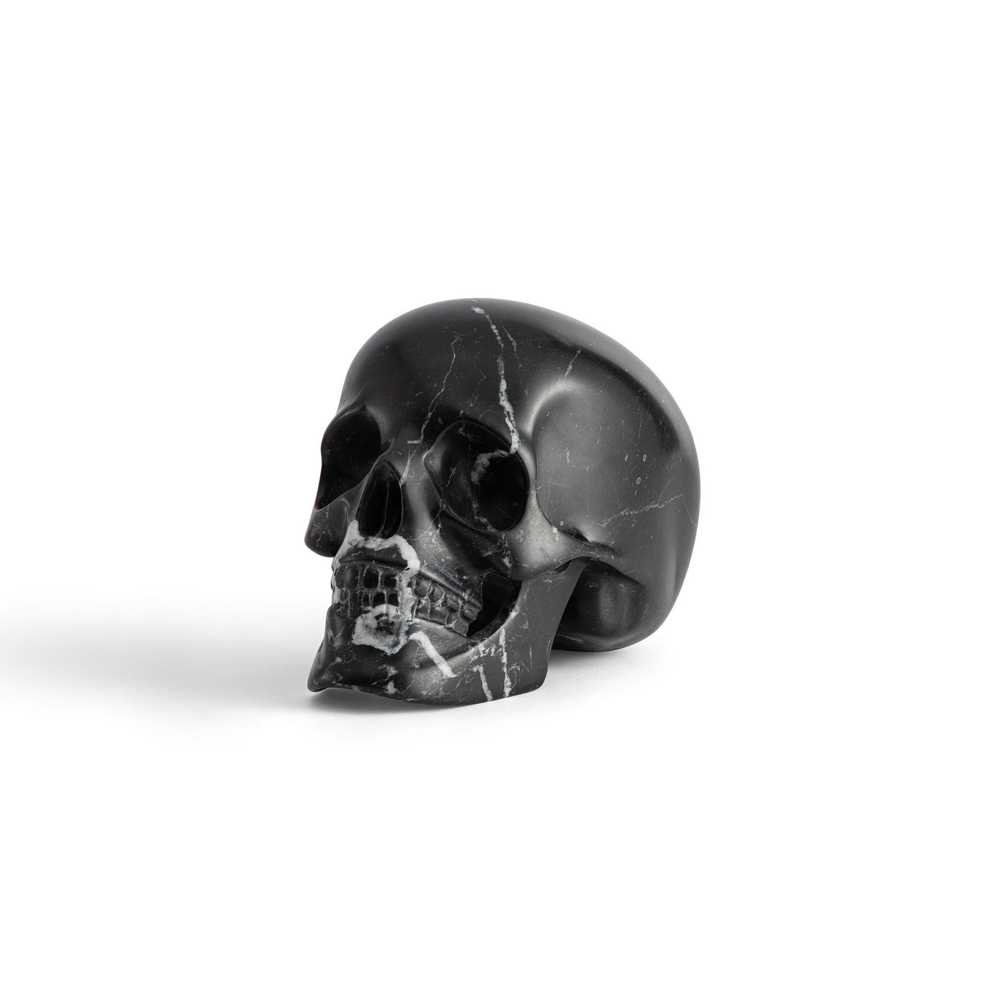 Welcome the mystique of our masterfully crafted Nero Marquina marble skull into your collection. Born of the captivating Nero Marquina marble, with its rich black hue, this piece presents an enticing study in contrasts, a dance between darkness and