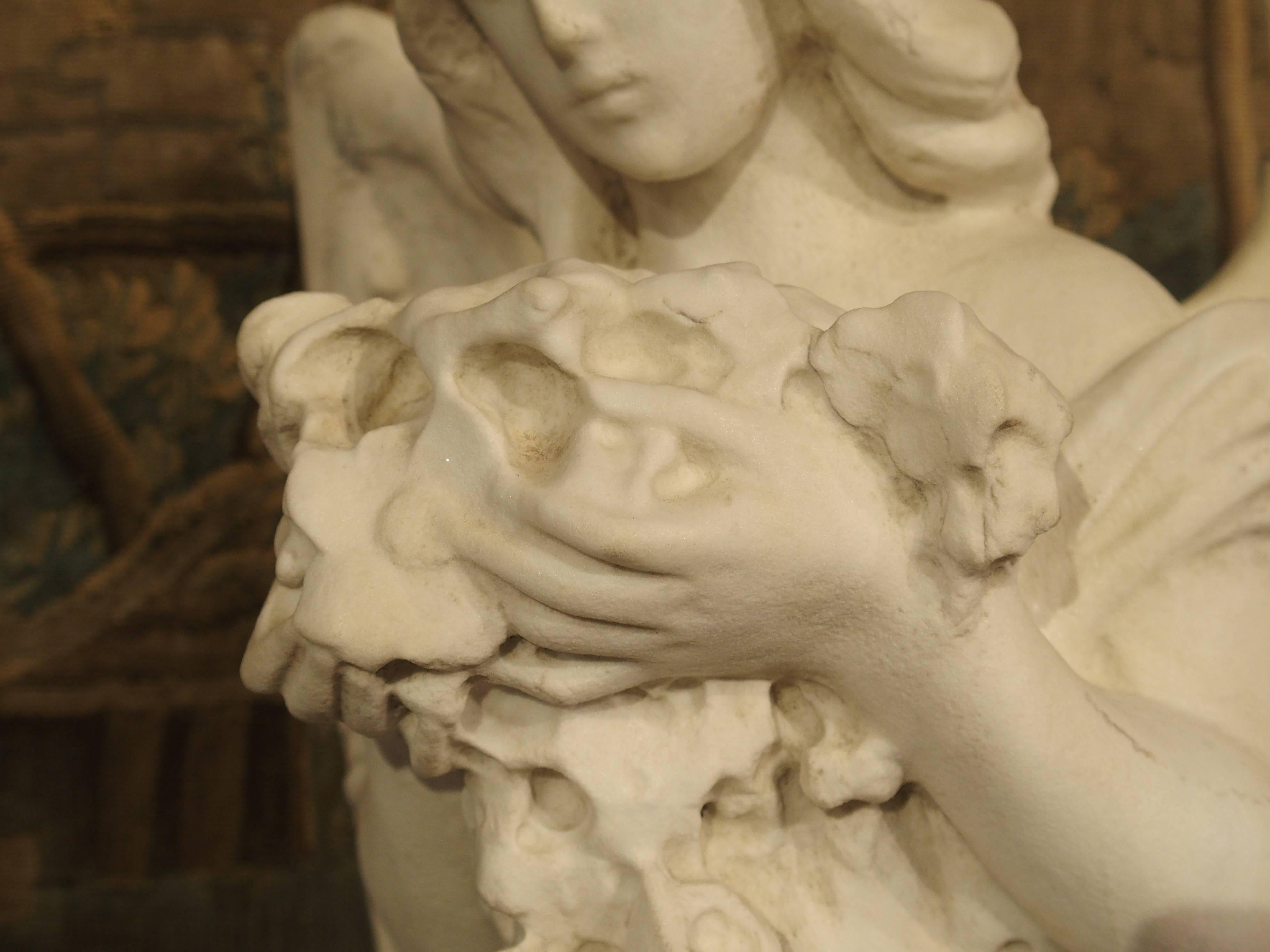 Carved Marble Statue of an Angel Holding a Bouquet 6