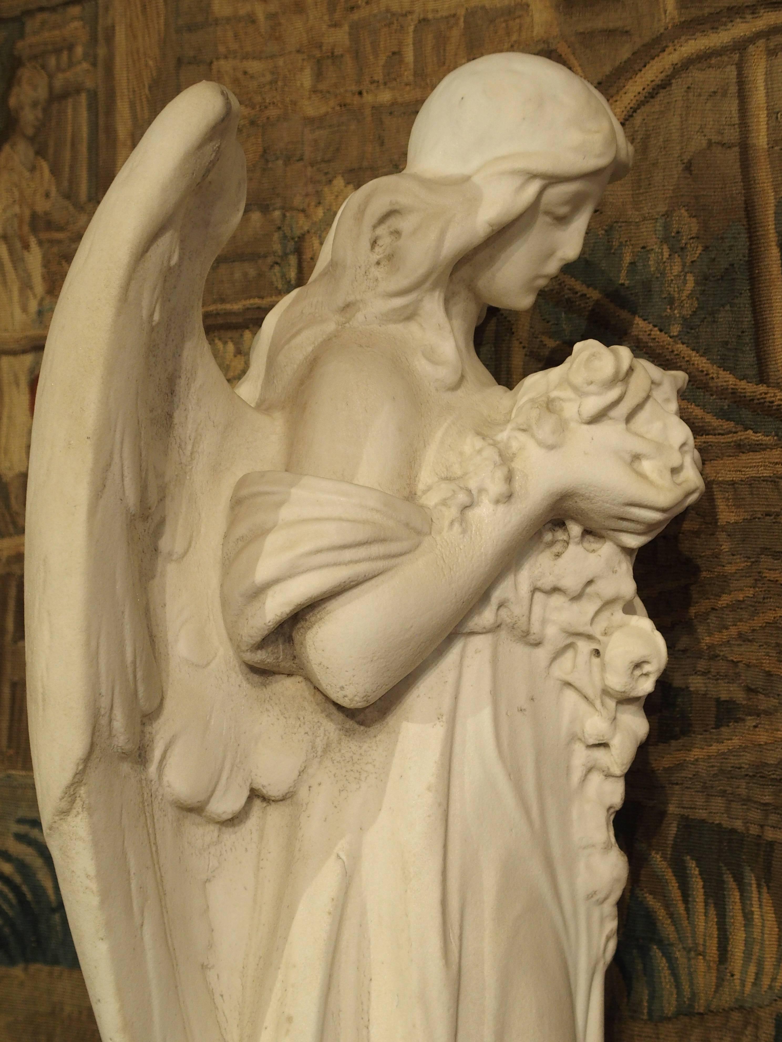Hand-Carved Carved Marble Statue of an Angel Holding a Bouquet