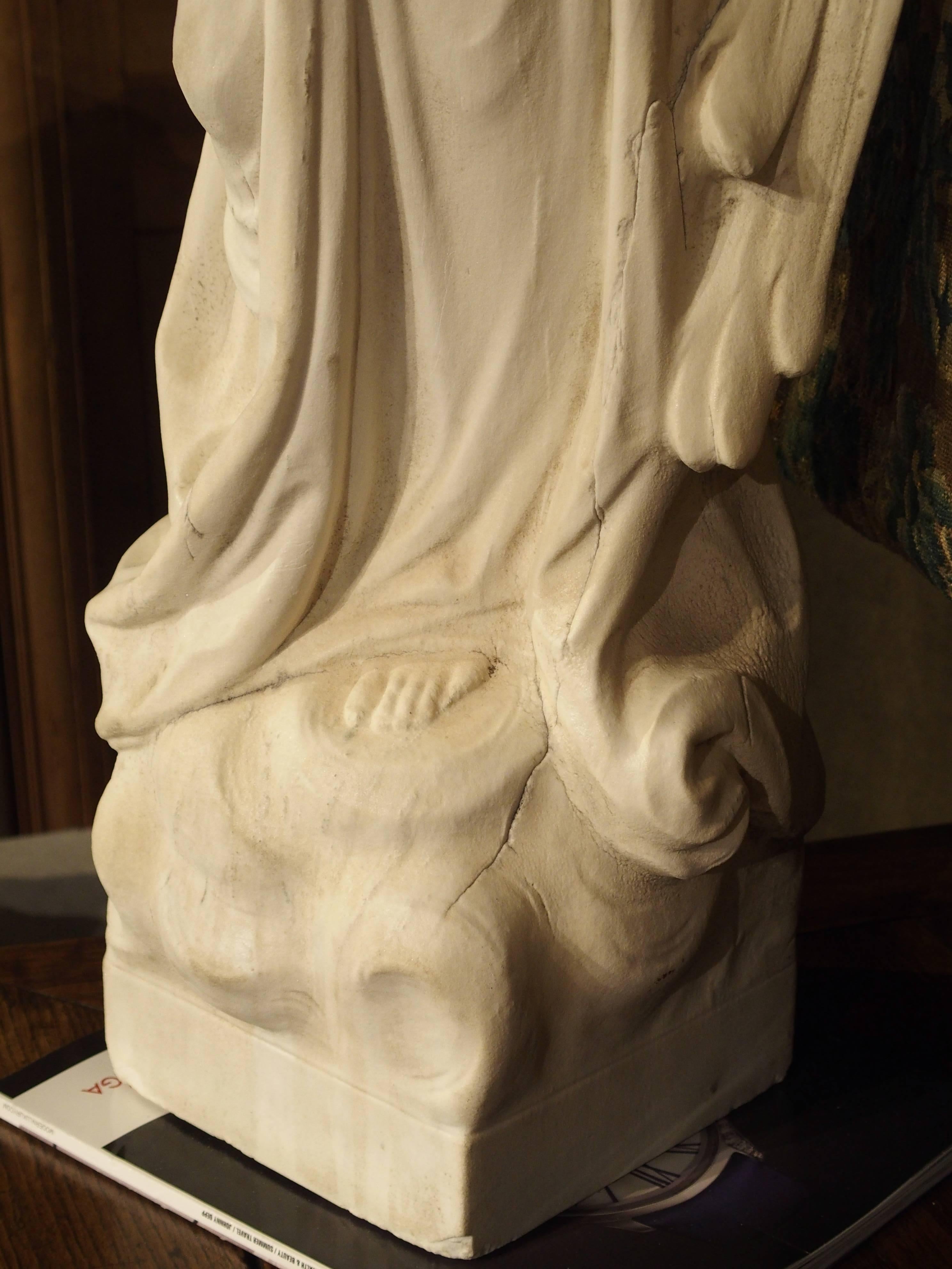 Carved Marble Statue of an Angel Holding a Bouquet 1