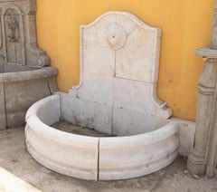 Carved Marble Wall Fountain with a Semicircular Basin and a Classical Rosette.