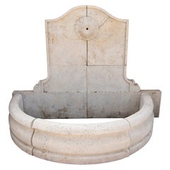 Carved Marble Wall Fountain with a Semicircular Basin and a Classical Rosette.