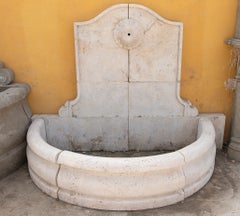 Carved Marble Wall Fountain with a Semicircular Basin and a Classical Rosette.