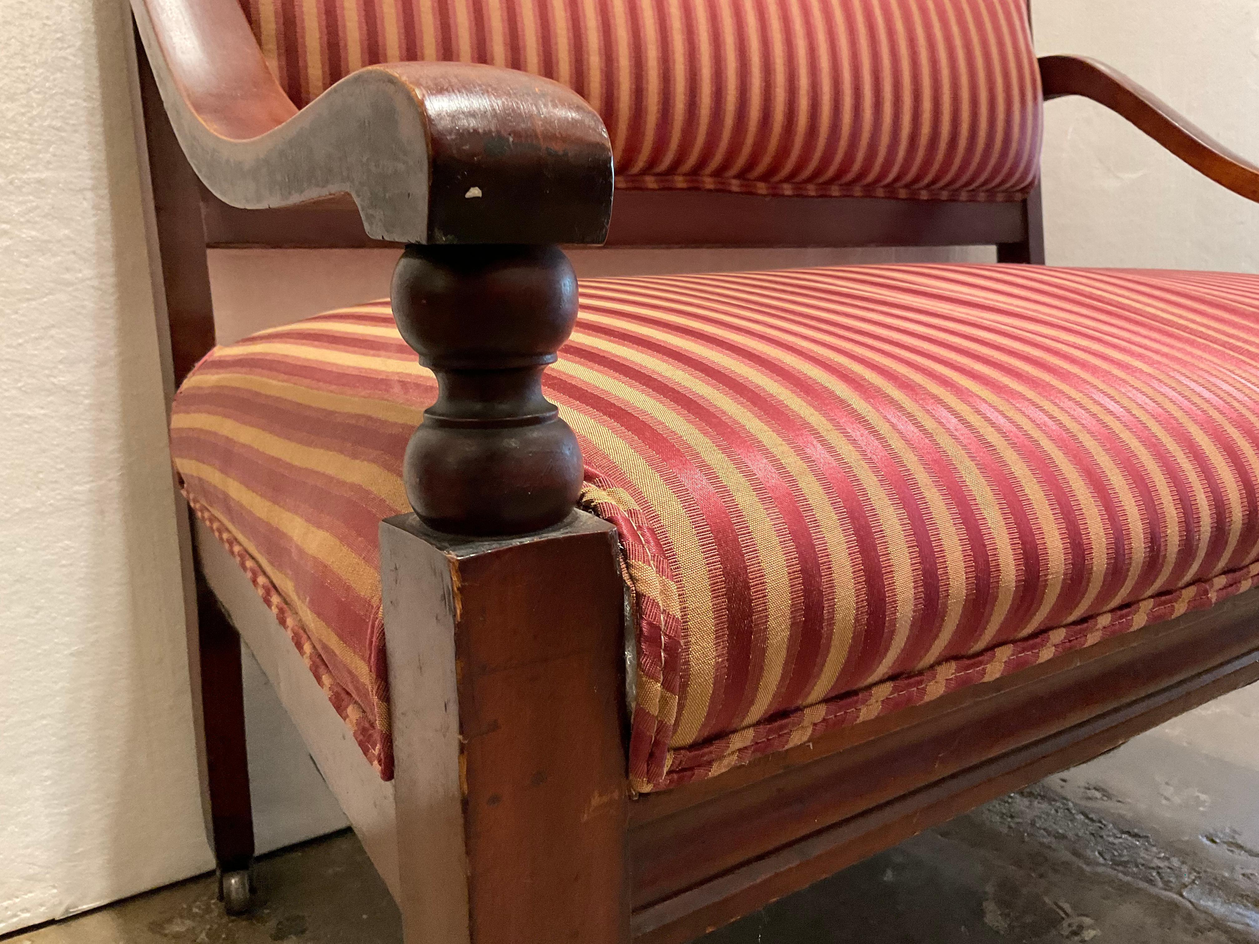 Early 19th century mahogany bench with beautiful antique red fabric.