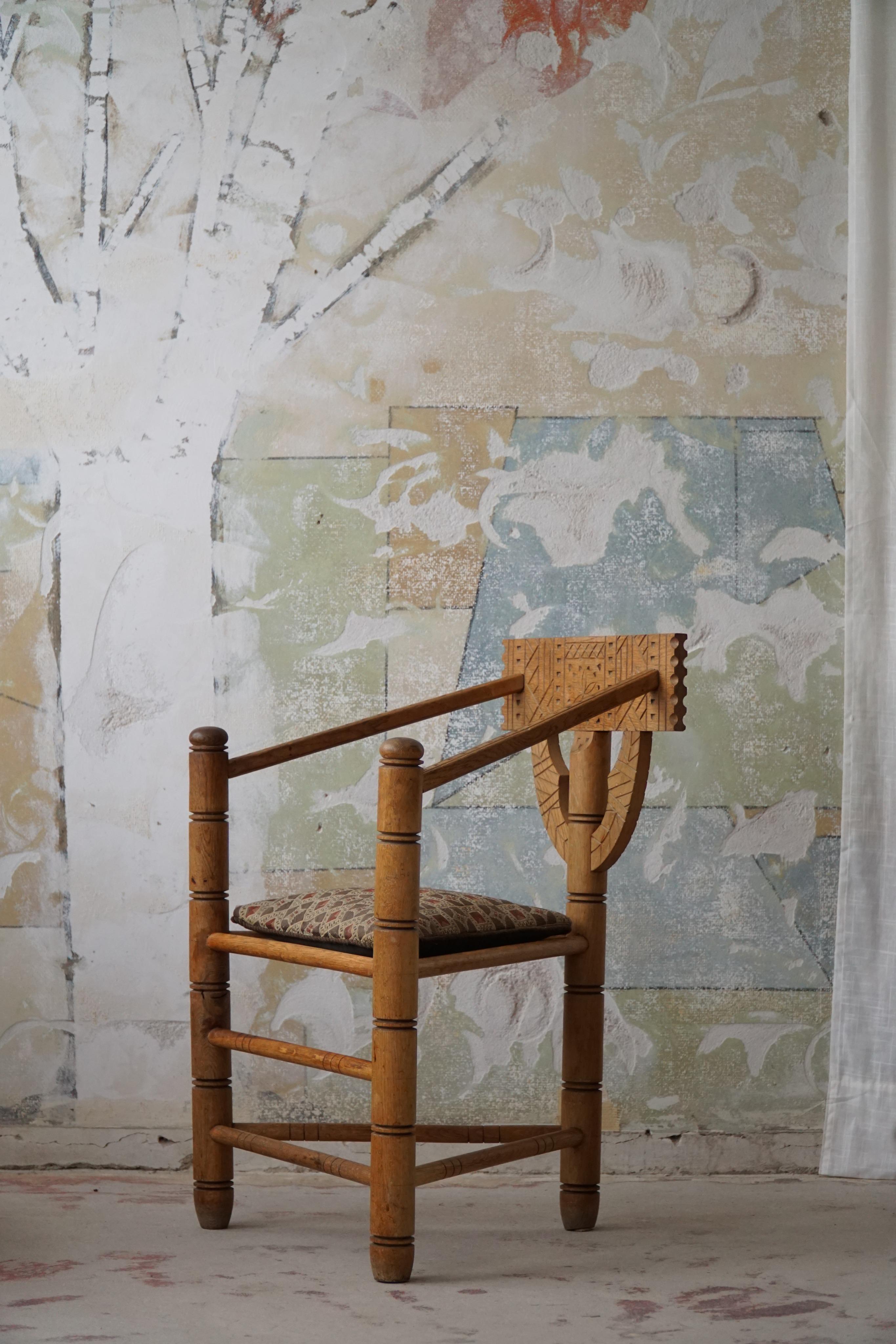A sculptural vintage Monk chair made in solid oak with a comfortable seat cushion. Carved by a Swedish cabinetmaker in the early 20th century. A truely authentic wabi sabi chair in an overall good condition with a fine patina.

This fine decorative