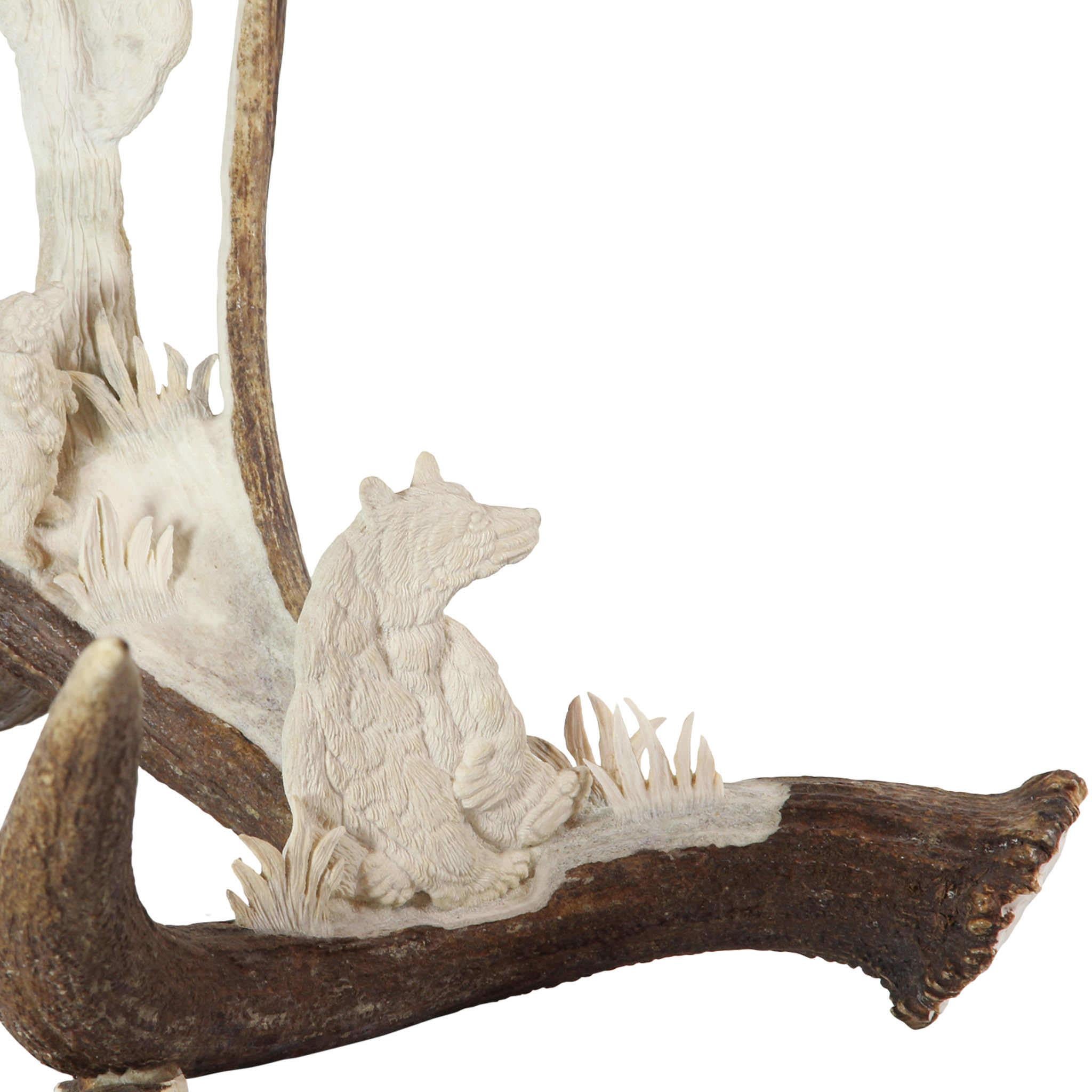 This stunning, carved moose antler features a mama bear sitting watchfully as her cubs climb a tree to get to a bee hive. Painstakingly carved by master artisan and Wyoming native Dee Jorgensen, the carving is an original one-of-a-kind from a shed