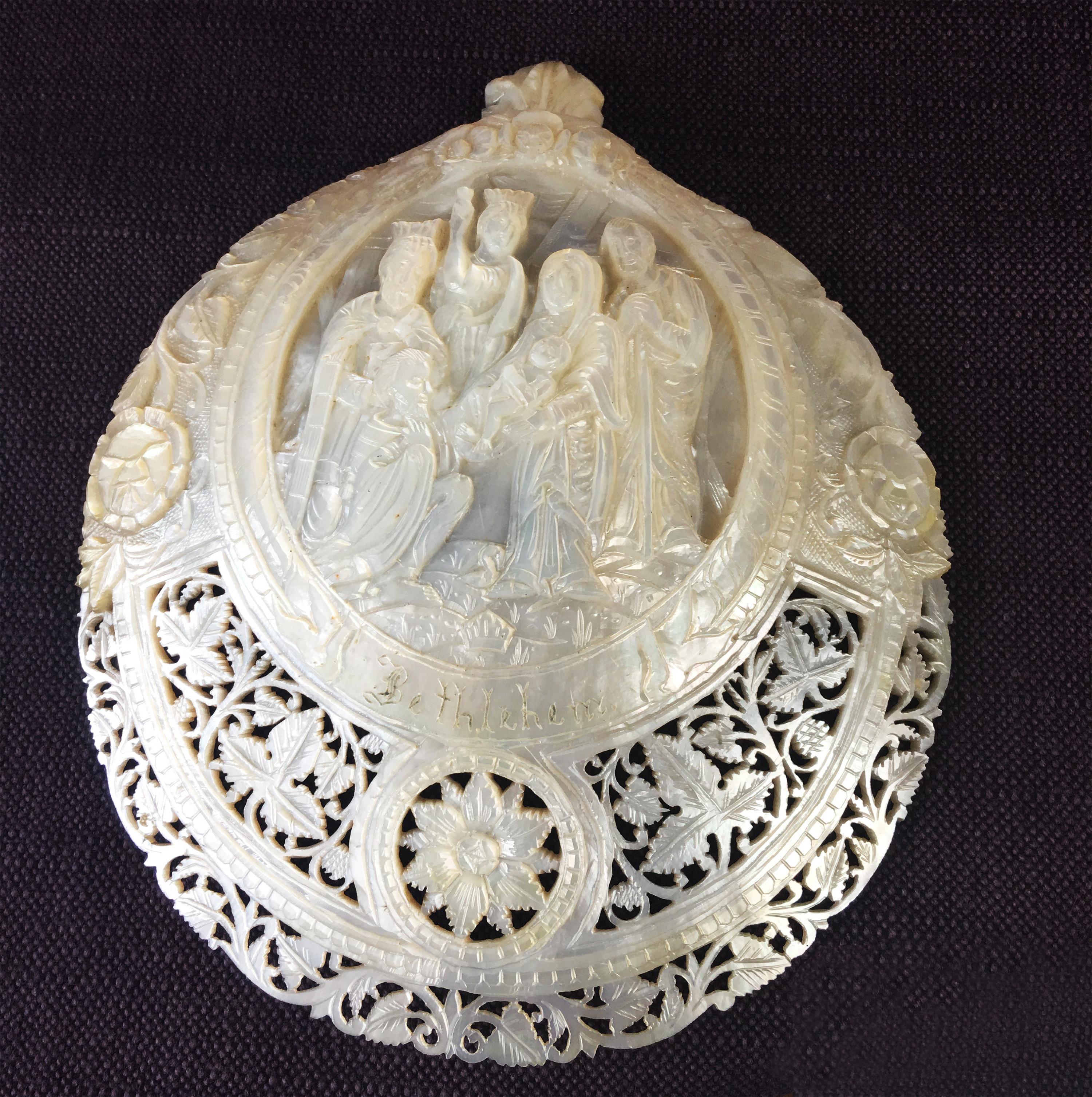 Chinese carved mother of pearl shell with nativity scene including the three wise men - Mar and Joseph and the baby Jesus. And inscribed with the word Bethlehem. Al within a foliate frame cartouche flanked by trefoils on a pierced foliate ground.