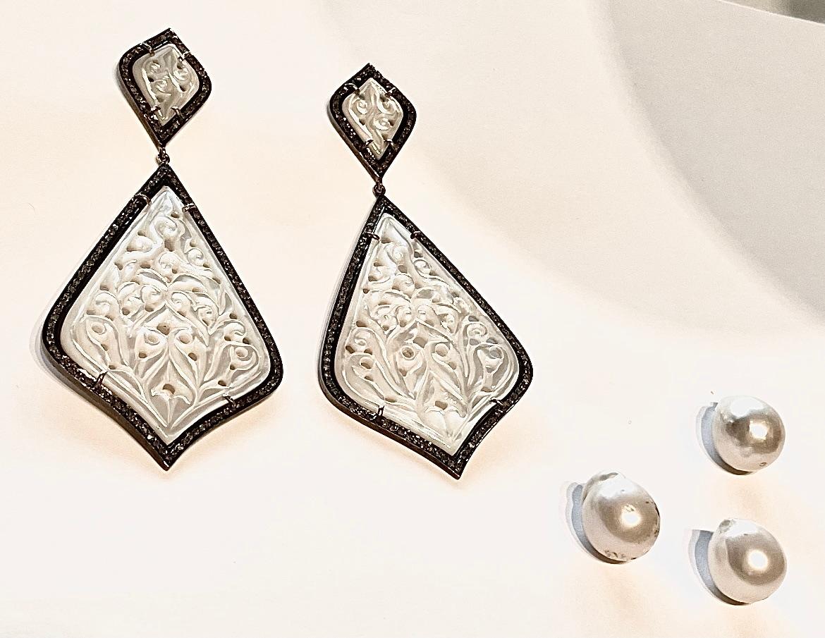 Description
Unique and stunning hand-carved white Mother of Pearl earrings surrounded with pave diamonds.
Item # E3130

Materials and Weight
White Mother of Pearl, 39 x 60mm kite shape, 84 carats.
Pave diamonds, 2.02 carats.
Posts and jumbo backs,