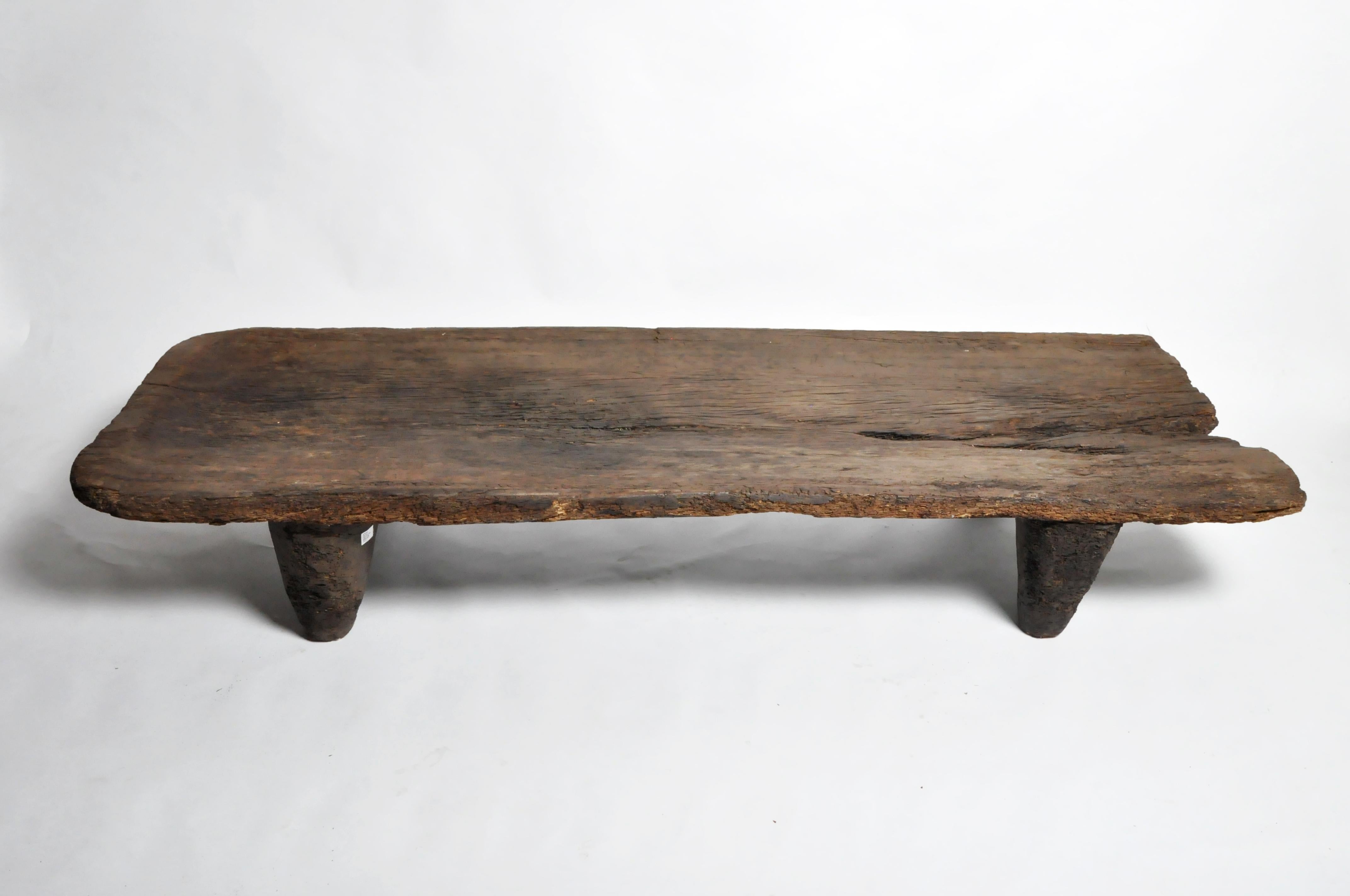 The Naga tribesman slept on elevated wooden beds to keep off the moist earth in their huts. Like most Naga artifacts, this bed is carved from a single piece of wood, circa 20th century. Wear consistent with age and use.
 