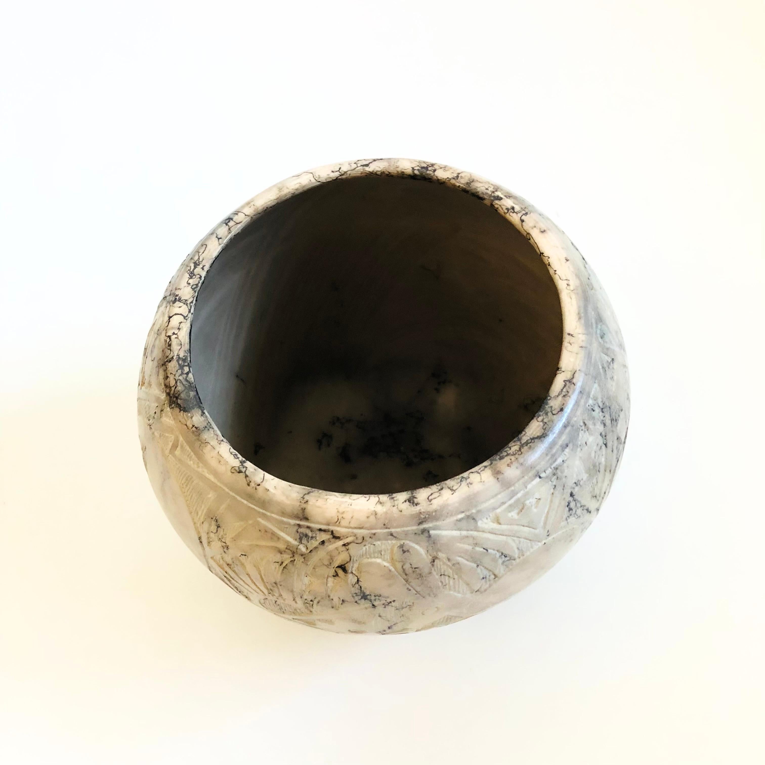 A beautiful vintage Native American horse hair pottery vase by well known Navajo artist Sally Garcia (born in 1940) of the Laguna Pueblo. White colored clay with a free form horse hair design in black lines. Intricate hand carved designs wrap around