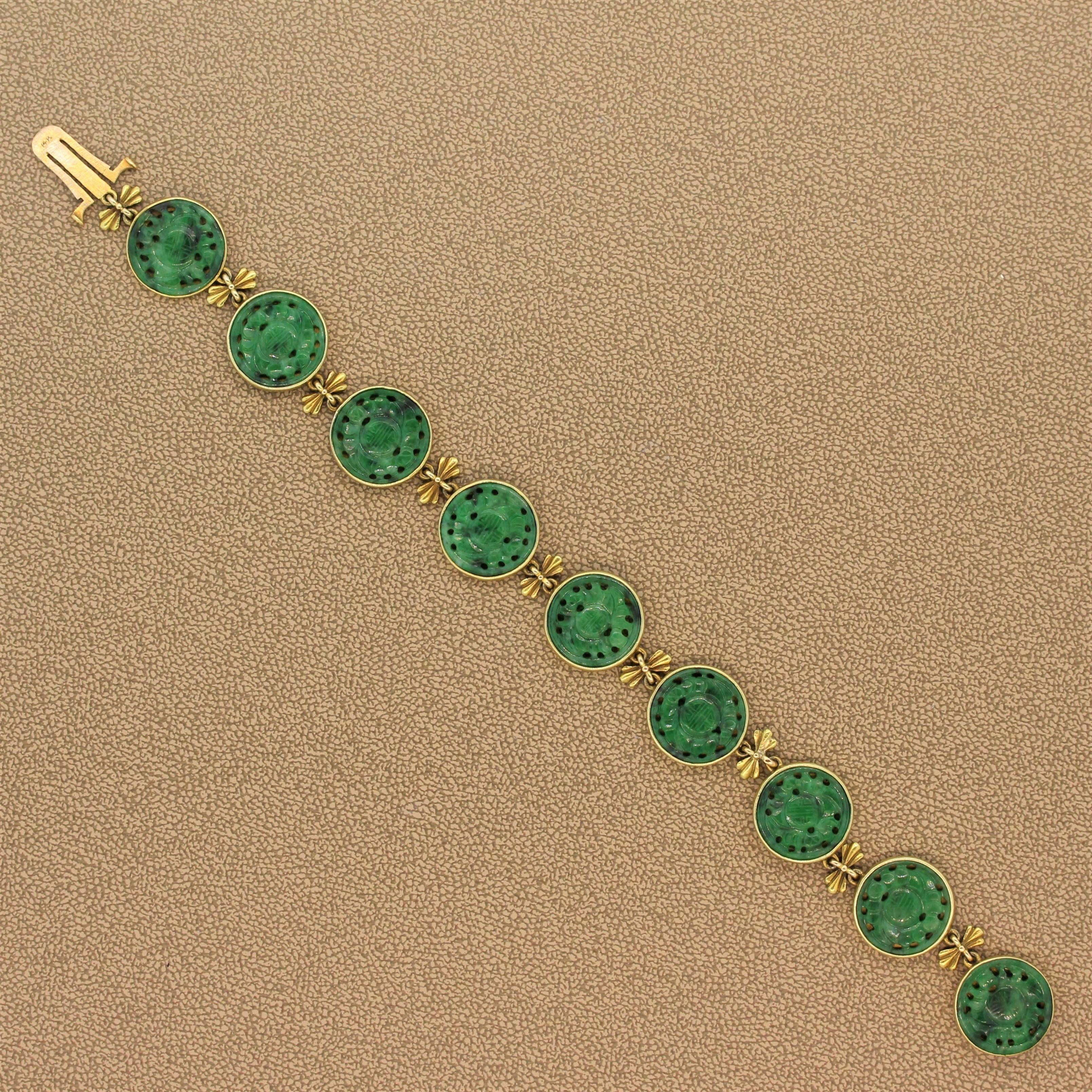An expertly crafted estate bracelet featuring nine dark green carved nephrite bezel set in 18K yellow gold. The links are attached using ornamental gold bows. The secure discreet lock also serves as a part of the design.

Bracelet Length: 8.00