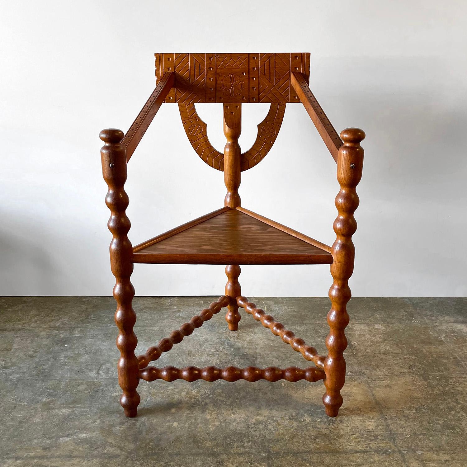 Swedish primitive monk chair
Sweden, early 20th century
Hand crafted artisanal chair unique in its composition and design
Made of solid oak and with intricately carved patterns and markings
Turned wood arms and legs 
Patina from age and use
Newly