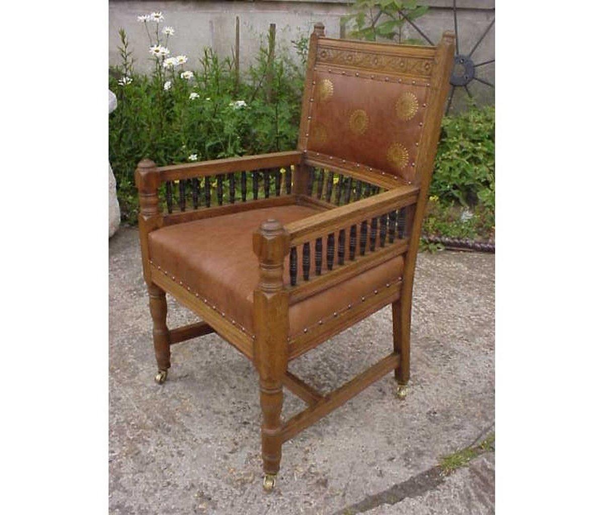 Edward William Godwin (attributed) probably for William Watt, a carved oak armchair, with ebonized spindles. 
See Soros, Susan Weber 'The Secular Furniture of E.W. Godwin', p. 126, illus. 171 for a comparable example.
Professionally re upholstered