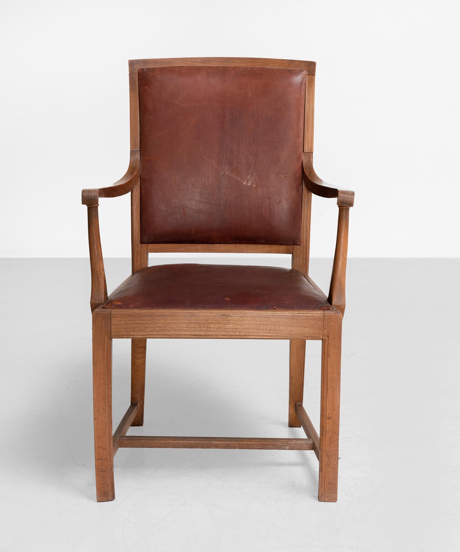 Carved oak and leather armchairs, England, circa 1930.

Well-constructed armchairs with beautifully patinated leather backs and seat.