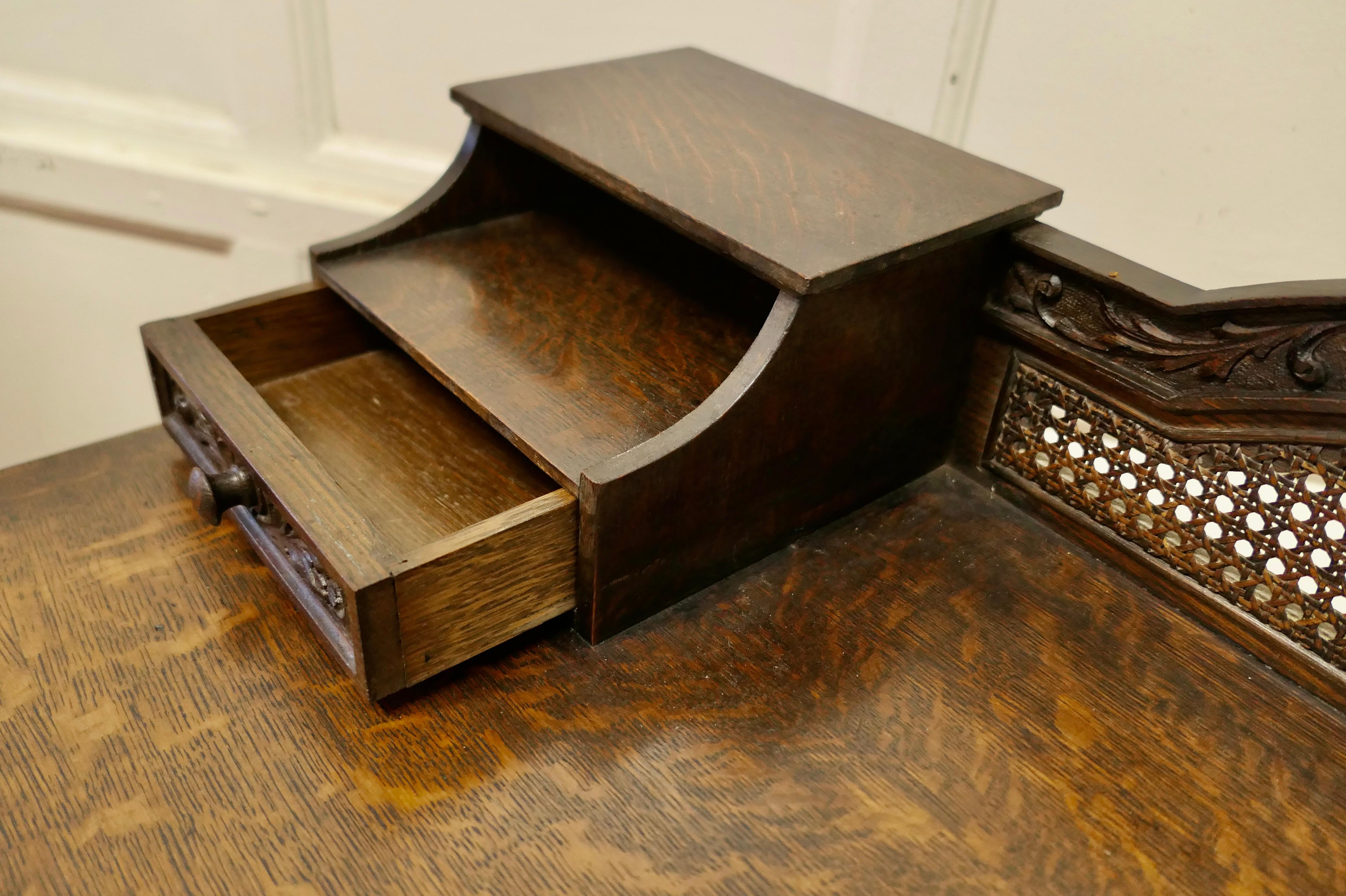 Arts and Crafts Carved Oak and Rattan Reception Desk For Sale