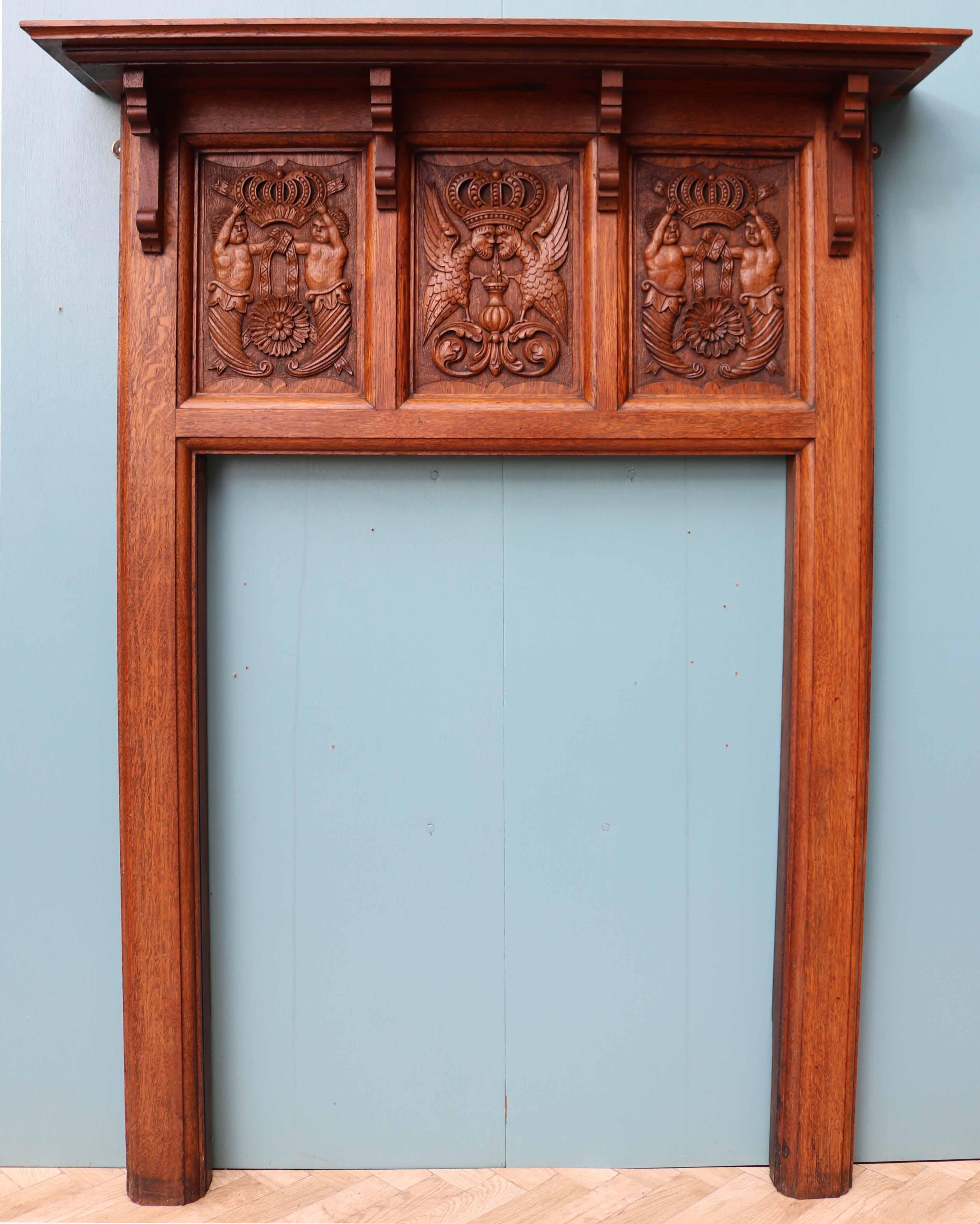 A good quality oak fire surround featuring three hand carved panels to the frieze. Reclaimed from a large private home in Hampshire, UK.

Opening Height 97 cm (38.18 in)
Opening Width 76 cm (29.92 in)
Width between outside of legs 95 cm (37.40