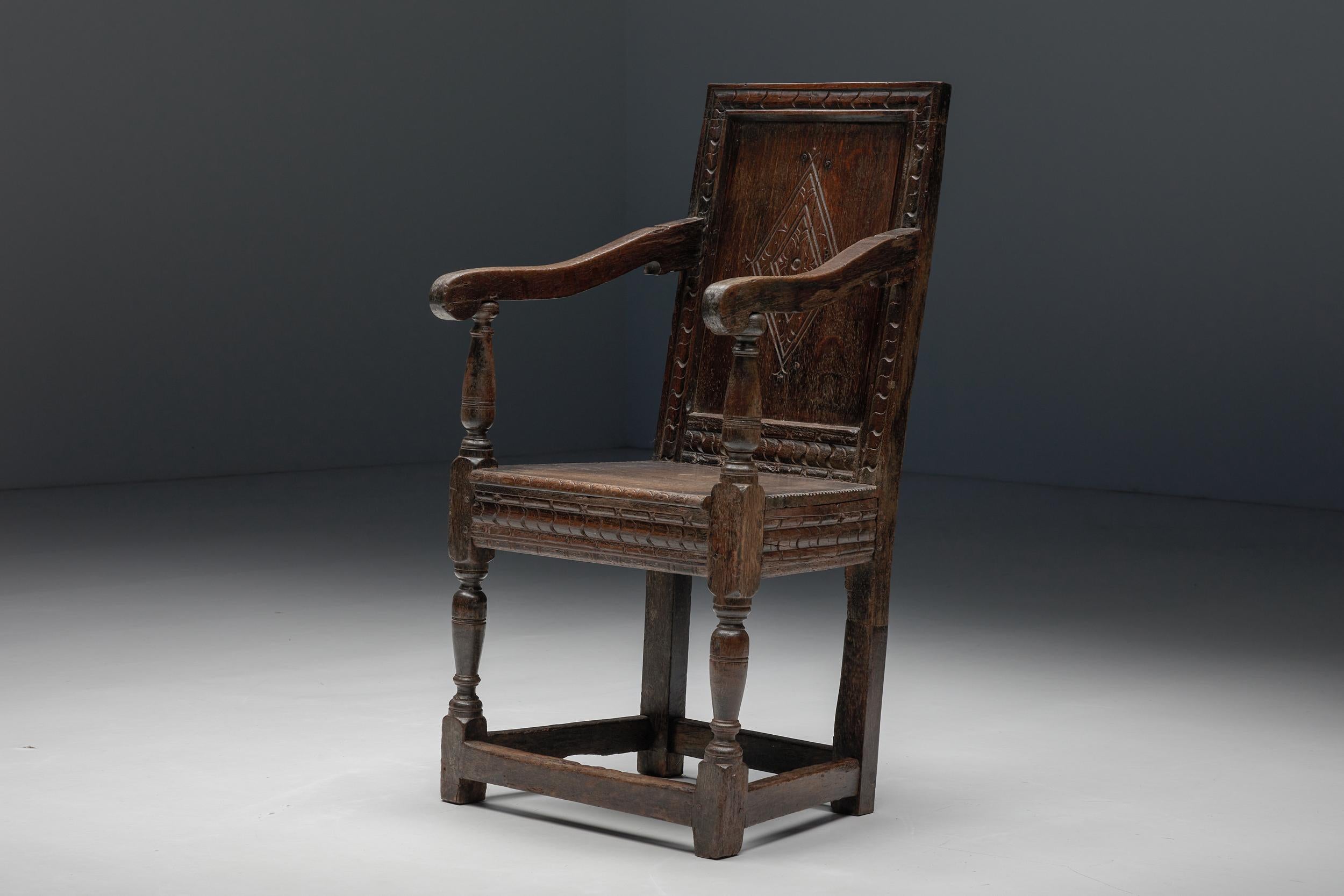 17th-century armchair, expertly carved from robust solid oak. With curved armrests and a subtly tilted back and impeccably preserved, this chair can serve as a side chair or as a beautiful addition to your office space.  This chair, in excellent