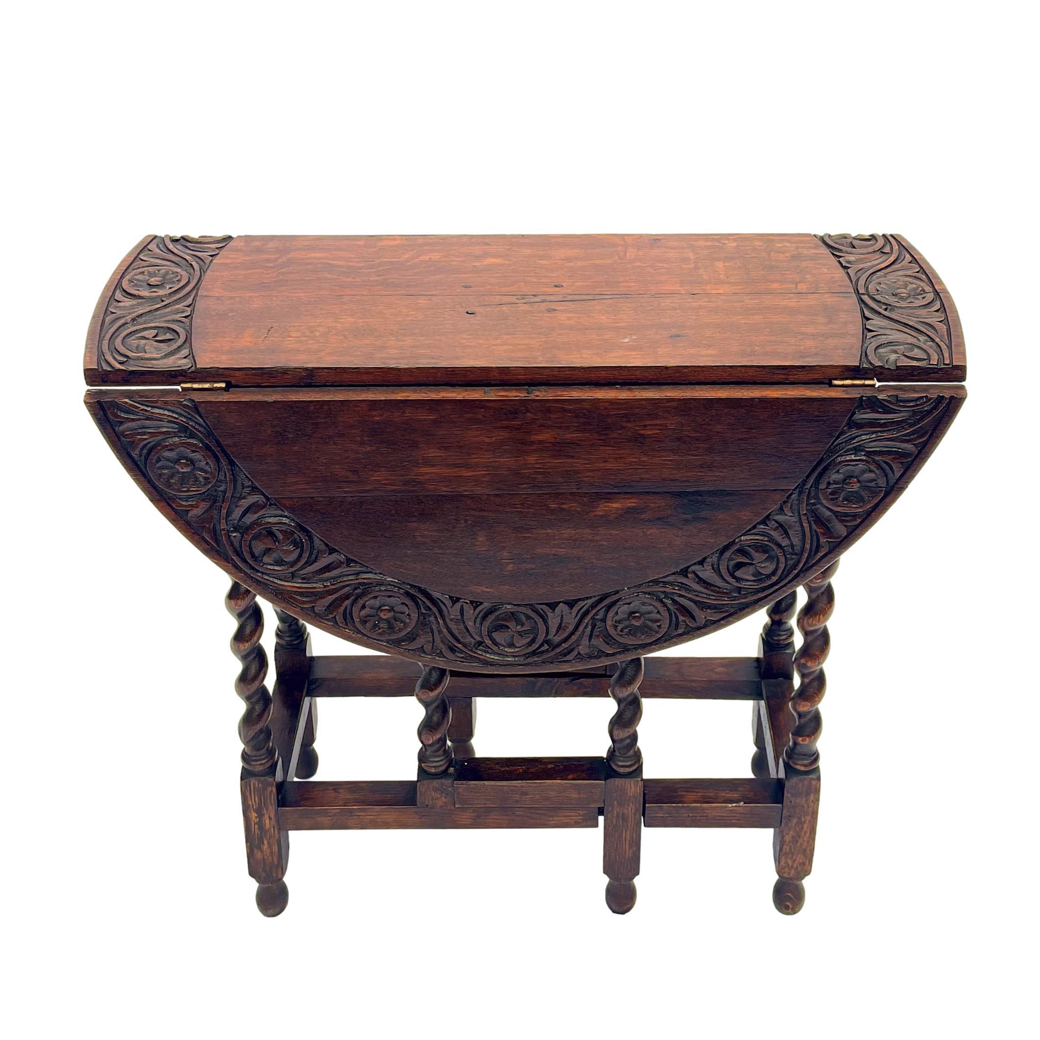 Solid oak drop-leaf table with a hand-carved stylized leaf and floral band to the top, the gateleg base with barley twist legs, English, circa 1900.
Measurements Closed: H-29 x W-42 x D-20 ins.
Measurements Open: Height-29 x diameter-68 ins.