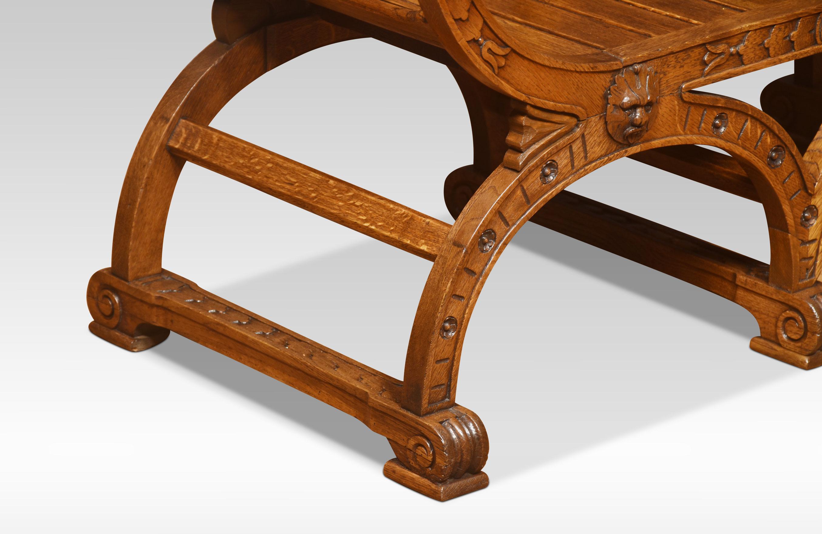 Oak bench the headed finials above carved backrests with scrolling details above planked seat surrounded by outswept arms. All raised up on shaped legs united by stretchers.\
Dimensions
Height 34.5 inches height to seat 15 inches
Width 44