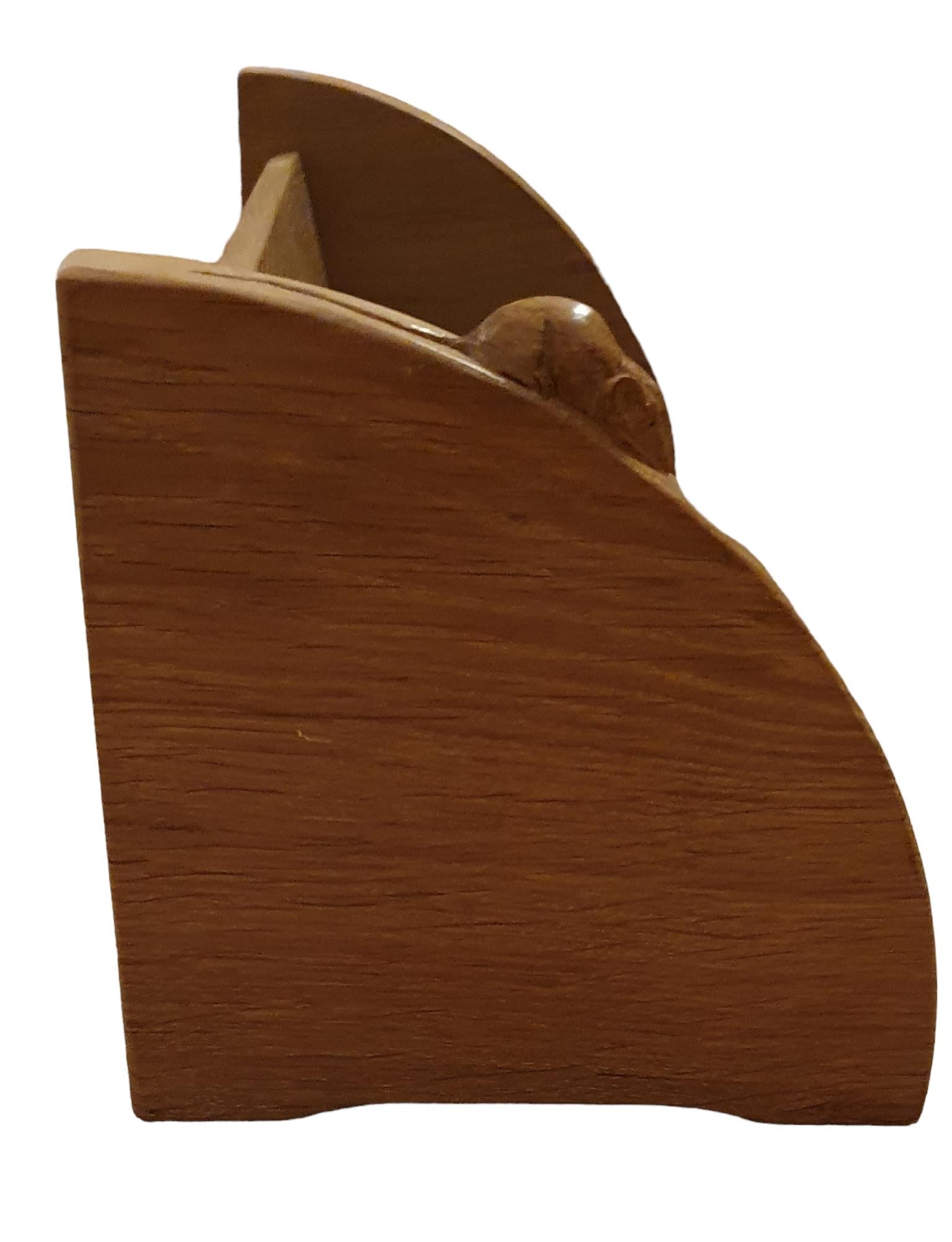 Stunning vintage oak book rack by Robert Thompson (also known as mouseman) from the 1960's. A simple and beautiful rack with the characteristic carved mouse signature. 

Robert 