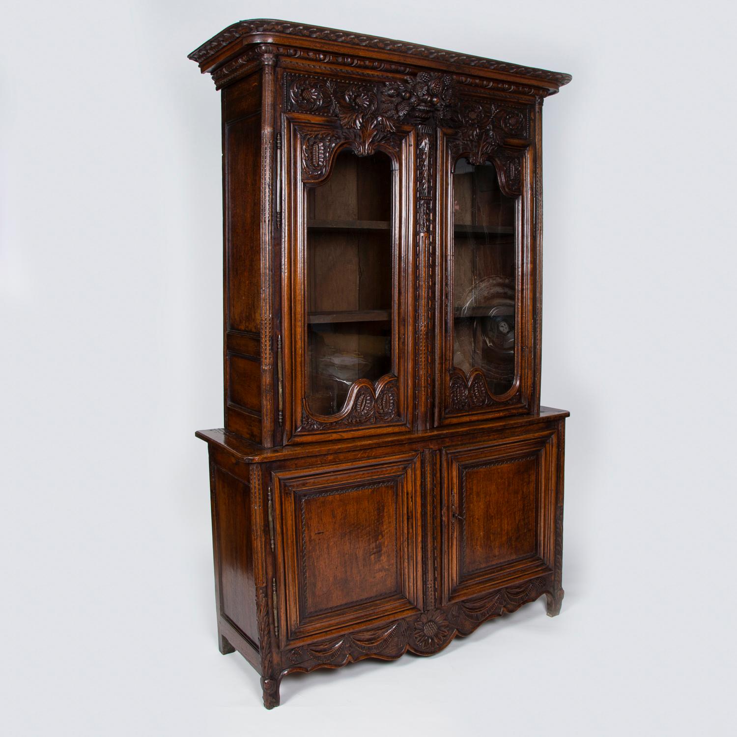 A large French mid-18th century highly carved oak cabinet 