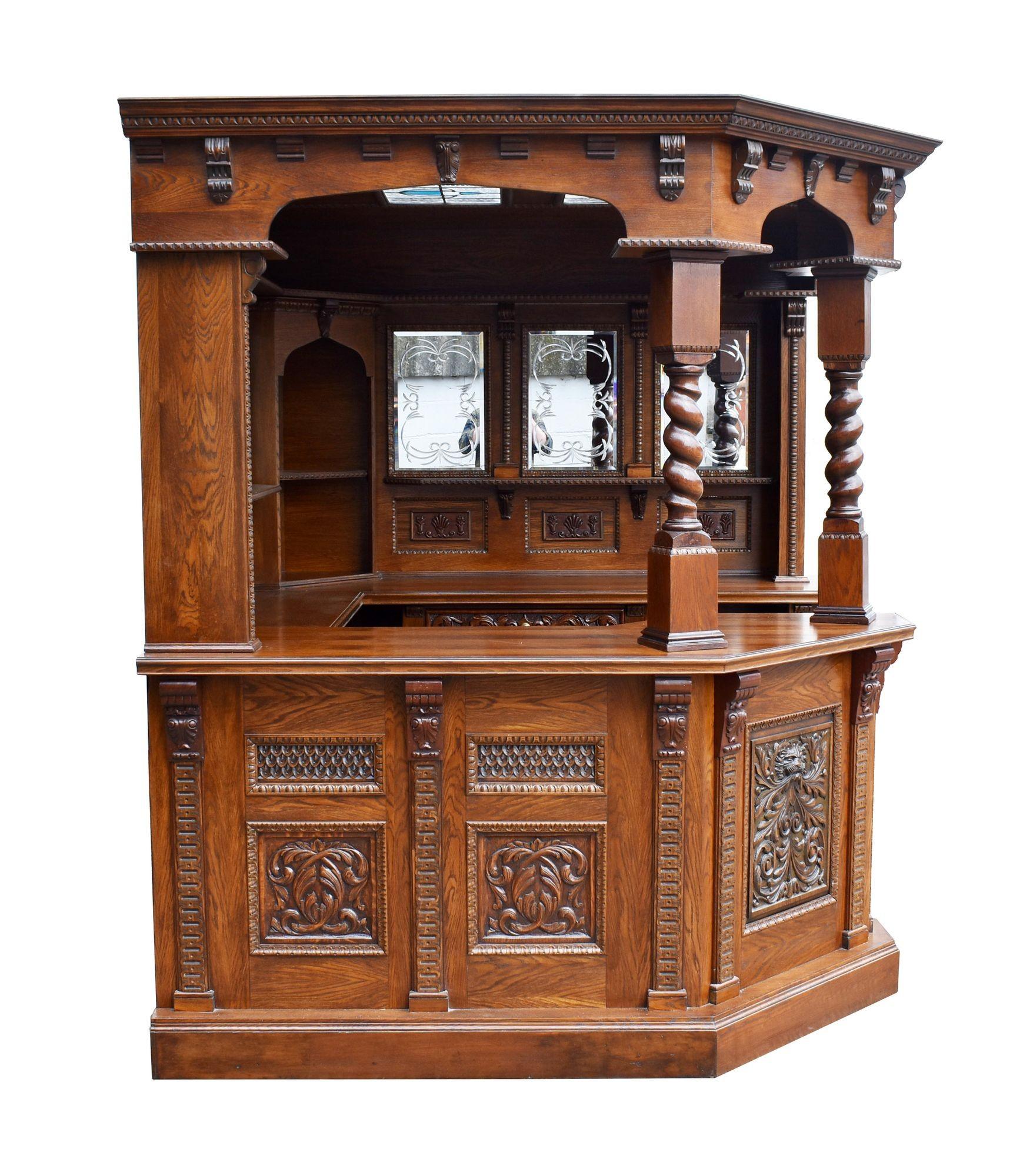 For sale is a good quality carved oak canted corner bar, the canopy with a stepped and flared cornice, with a decorative leaded glass panel in the ceiling, supported by two barley twist columns at the front, the back of the bar is decorated with