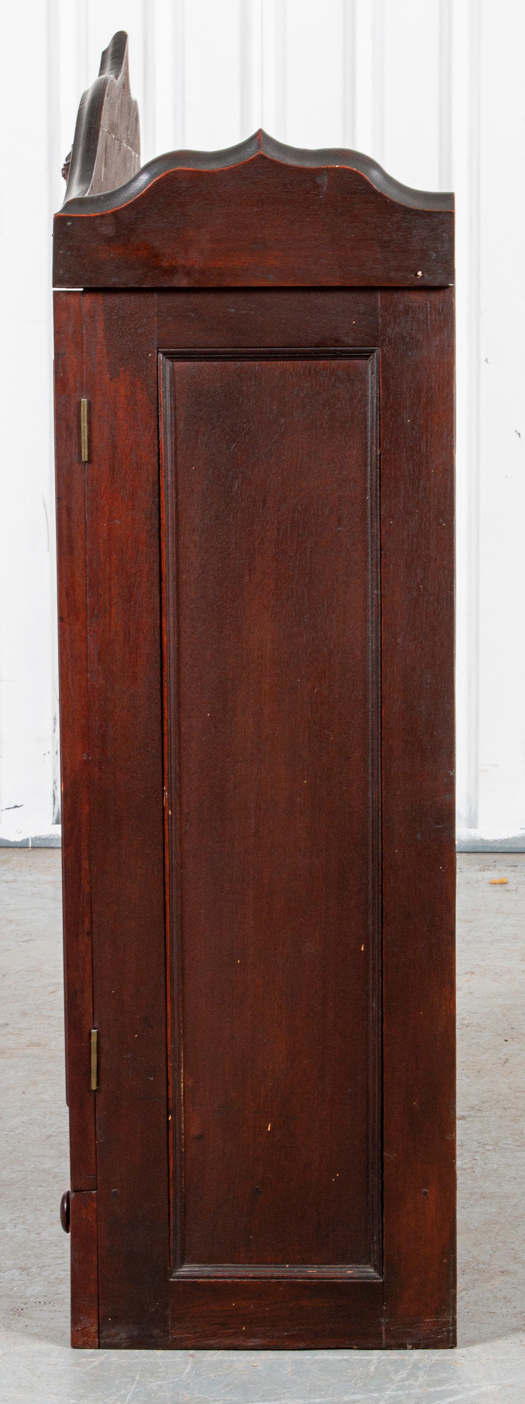 Carved oak cupboard with two glass doors and cartouche detail.