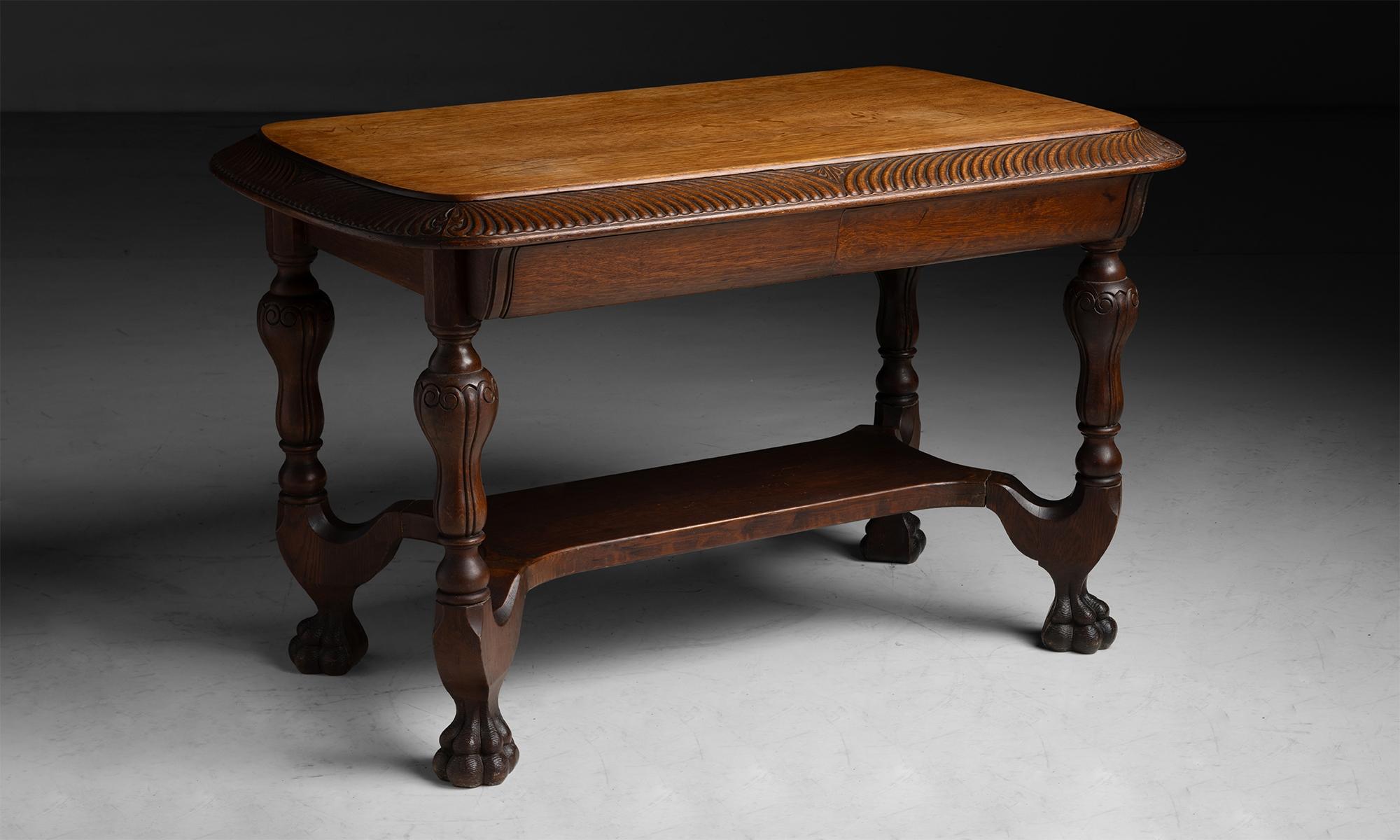 Carved Oak Desk
England circa 1920

Detailed carving, with single drawer on both sides, lower shelf and lion feet.

48.25”L x 30”d x 31”h
Ref. TABLE1191