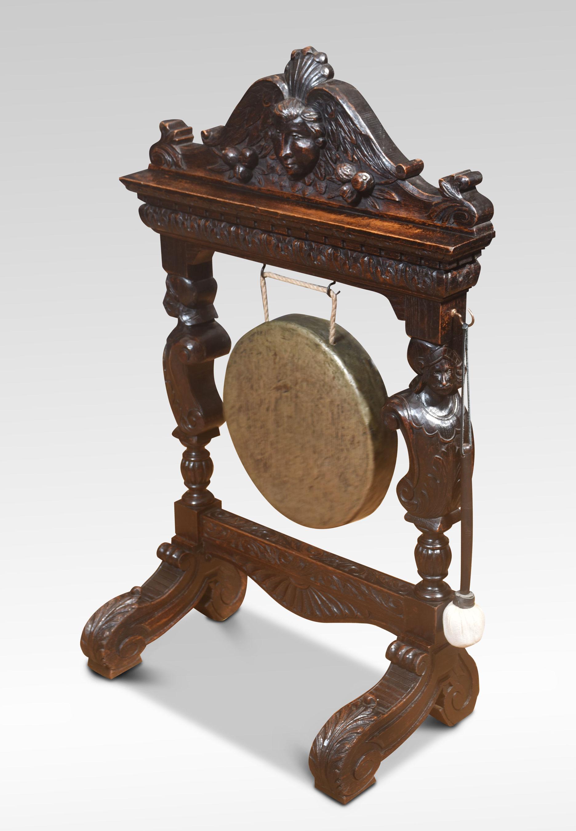 Carved oak dinner gong, the oak frame with mask pediment above a leaf-carved scroll decorated frame supporting the original brass gong. All raised on scrolling legs.
Dimensions
Height 42.5 Inches
Width 27.5 Inches
Depth 15 Inches