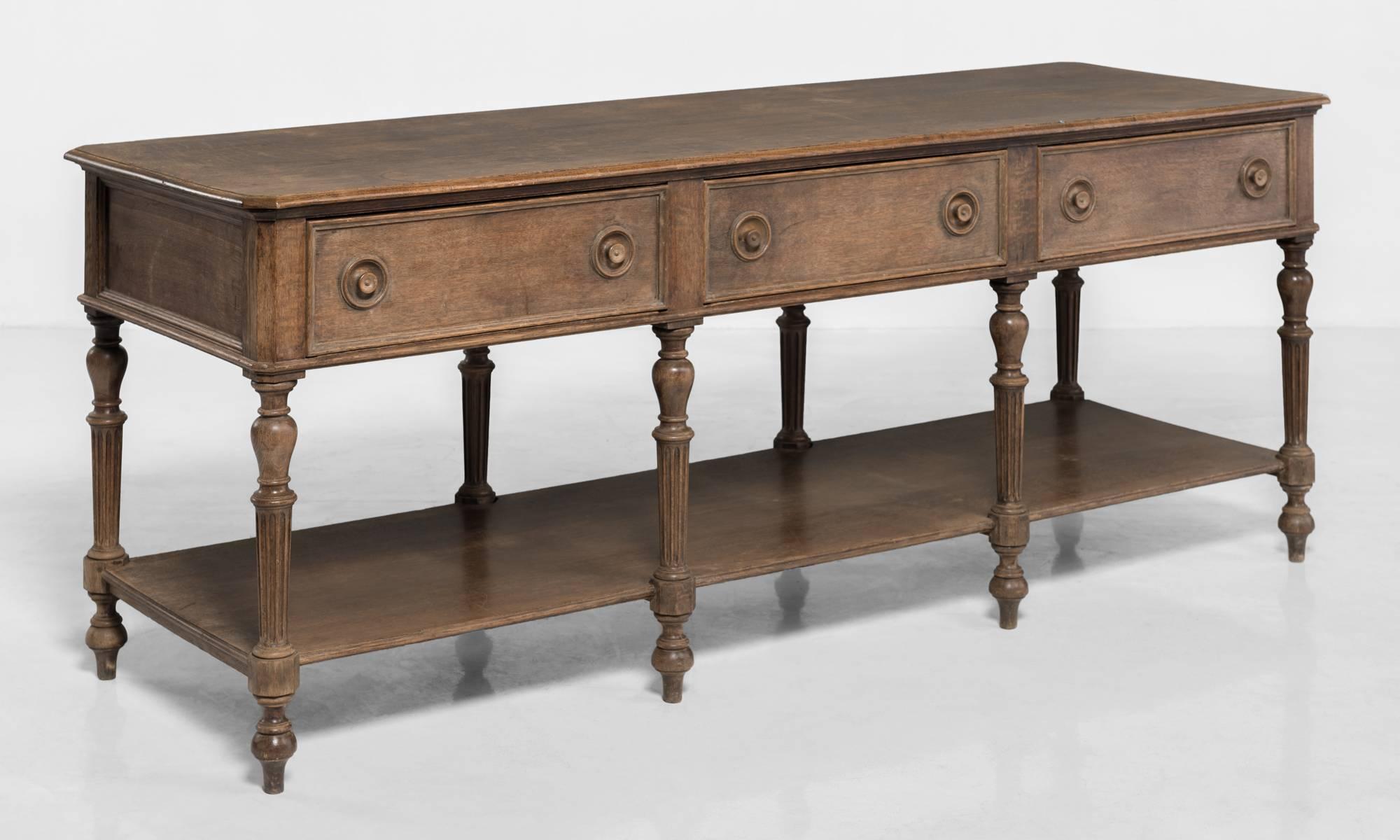 Carved oak drapers table, France, circa 1890.

Solid oak construction, with unique carved wooden knobs and legs.
  
