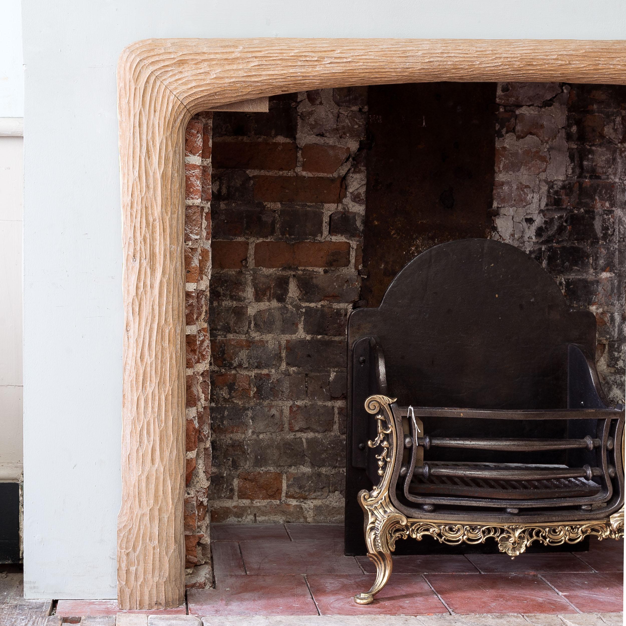 1970s Carved oak fire surround by John Makepeace OBE (b.1939), of naturalistic form.

Opening width 117 cm x 91 cm high.