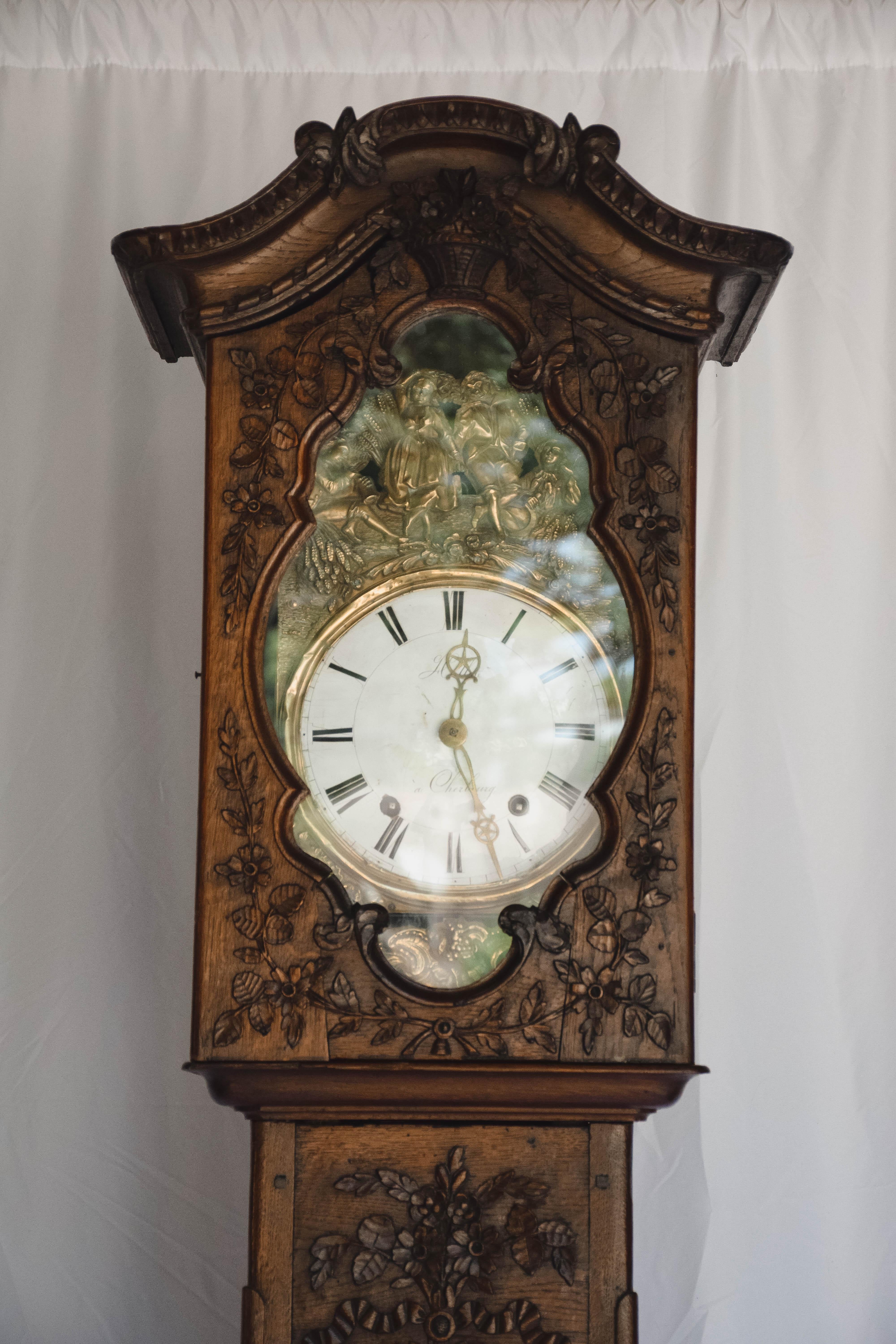 Found in Northern France, this wonderful 18th c. Longcase (grandfather) from the Normandy region of France is truly a special find.  Beautifully detailed, the exterior is carved with a floral and foliage motif sitting on cabriolet feet. The face of