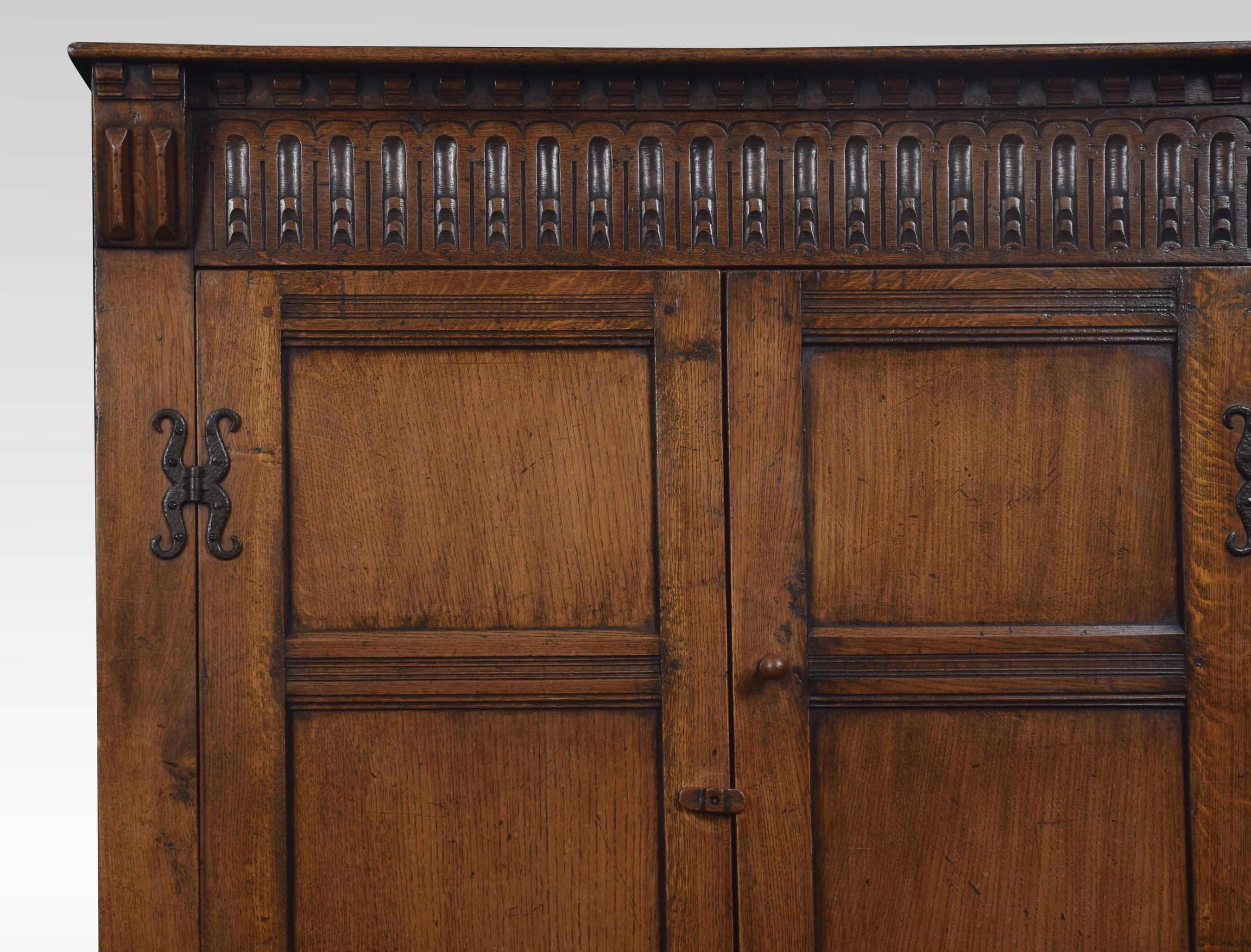 Solid oak two-door wardrobe, the molded cornice above carved decoration in the Jacobean style. The large paneled doors opening to reveal a hanging area. All raised up on bracket feet.
Dimensions:
Height 73 inches
Length 48 inches
Width 21 inches.