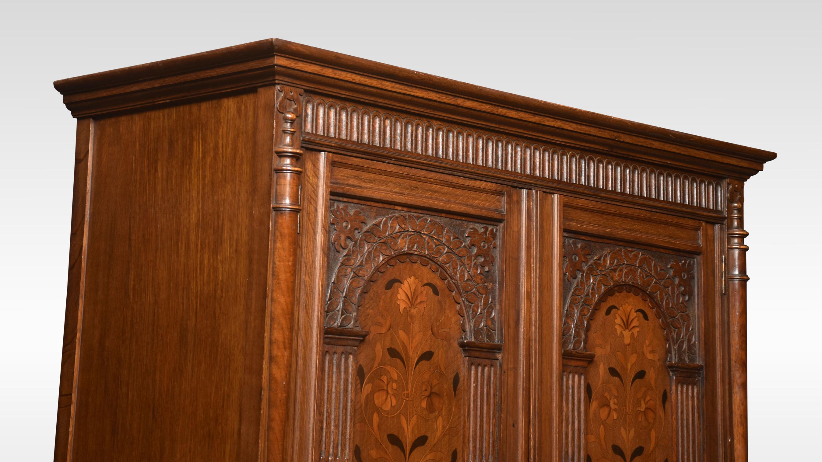 Carved oak hall robe, the moulded cornice above two carved paneled doors with scrolling foliated detail. The large doors opening to reveal a hanging area. All raised on square feet.
Dimensions
Height 72 Inches
Width 45.5 Inches
Depth 19.5 Inches.
