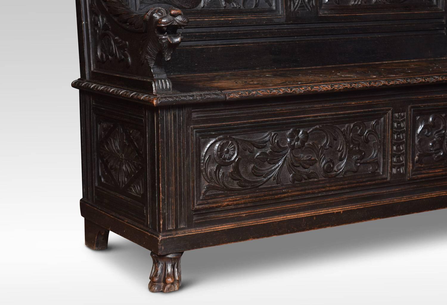 19th century carved oak hall settle, with panelled back depicting Merlion and scrolling relief. Above lift up seat flanked by carved Merlion headed arm rests. To the panelled base with floral motifs. All raised up on claw feet.
Dimensions:
Height