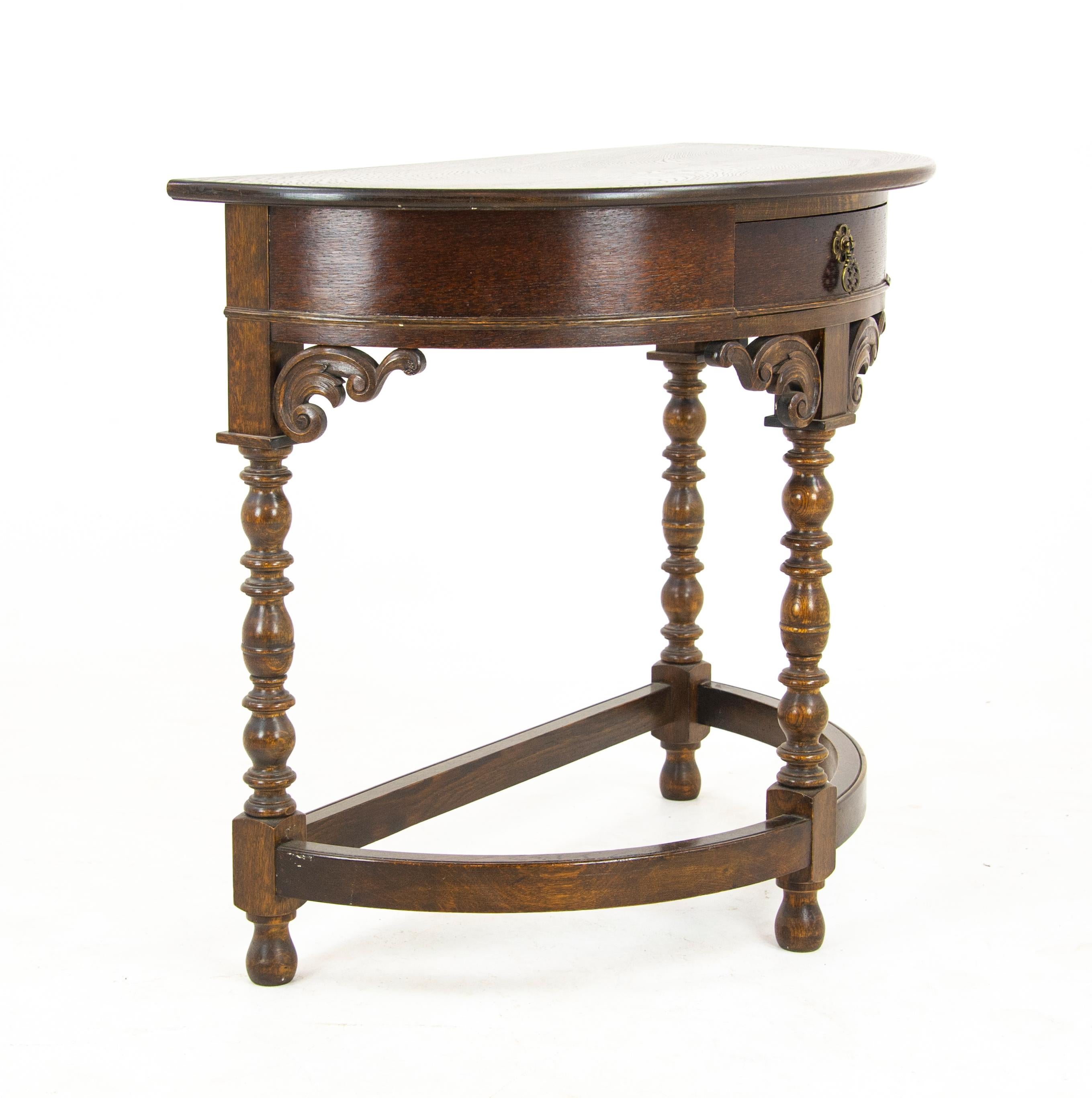 Carved Oak Hall Table, DemiLune Table, Half Moon Table, Scotland 1920, Antique Furniture, B1173

Scotland 1920
Solid Oak with Original Finish
Bow Front Top
Carved Single Drawer with Original Brass Hardware
Turned Bobbin Legs
Ending with Curved