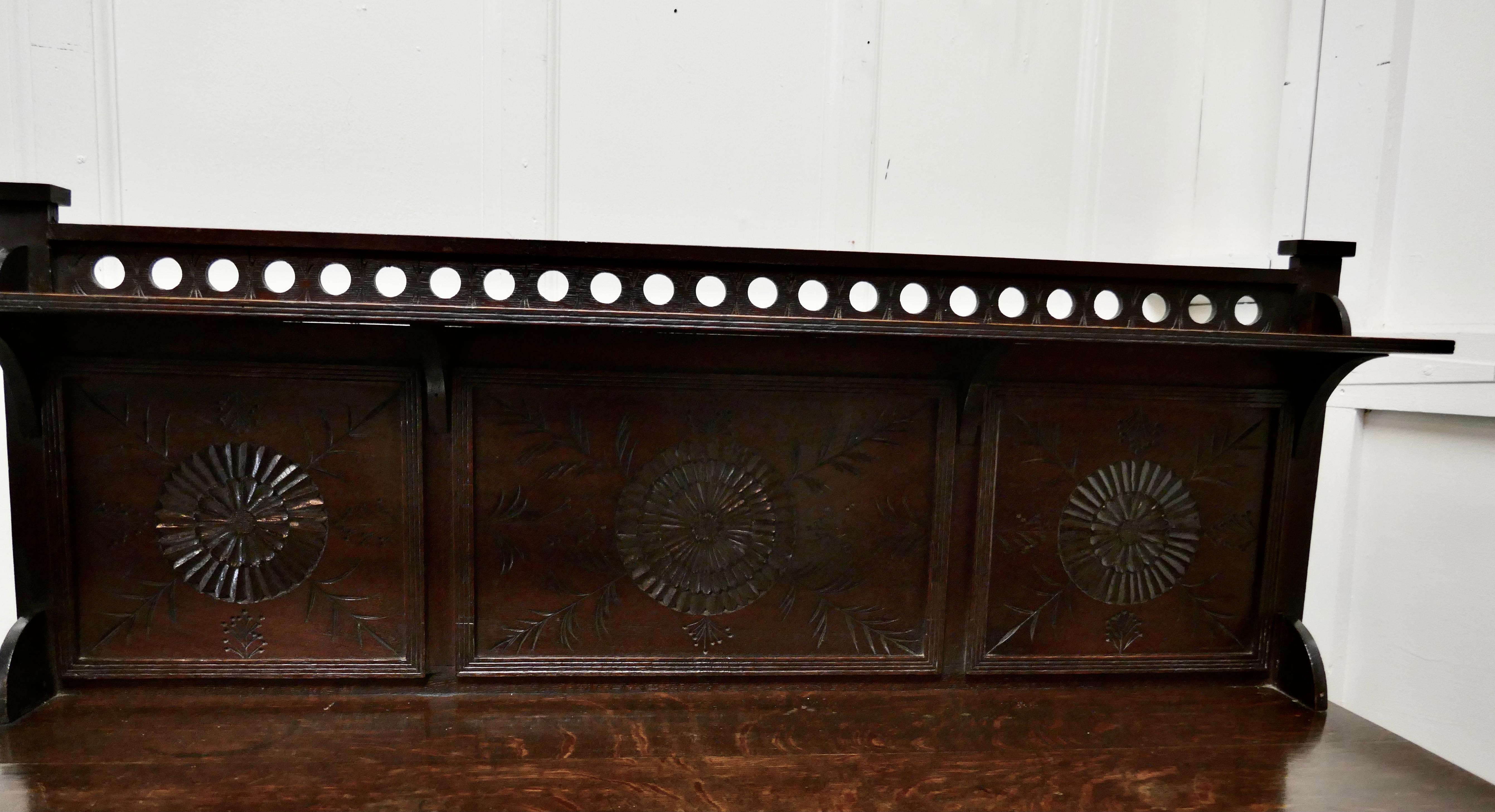 Carved oak housekeepers chest of drawers

This is a lovely antique chest of drawers, the chest has a back gallery with a small shelf over, below there are 16 drawers
The splash back and the drawer fronts are carved and they have brass