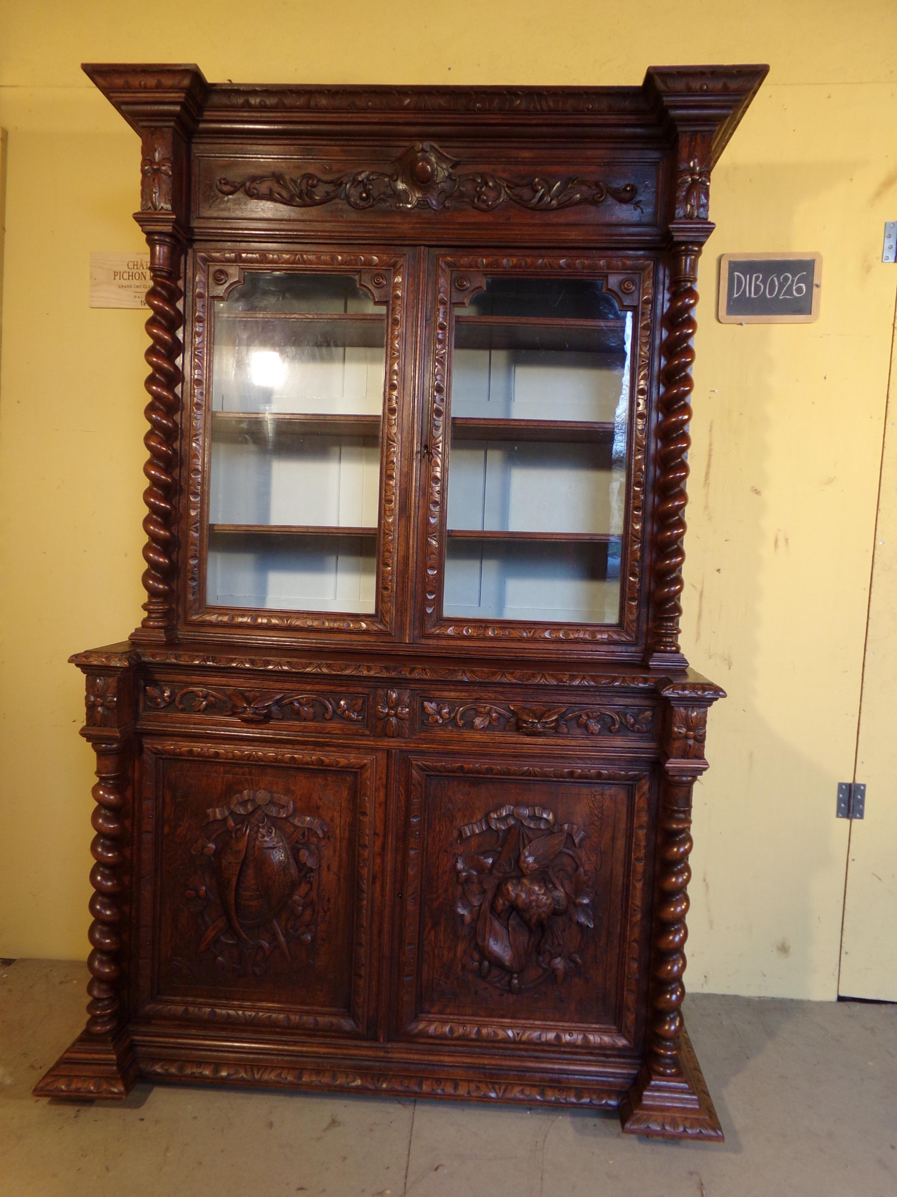A good black forest style hand carved oak bookcase or gun cabinet circa 1880. This piece is presently set up as a book case however if you wish to use it as a gun cabinet we will convert it to hold 6-8 guns at no extra charge. Please note the last