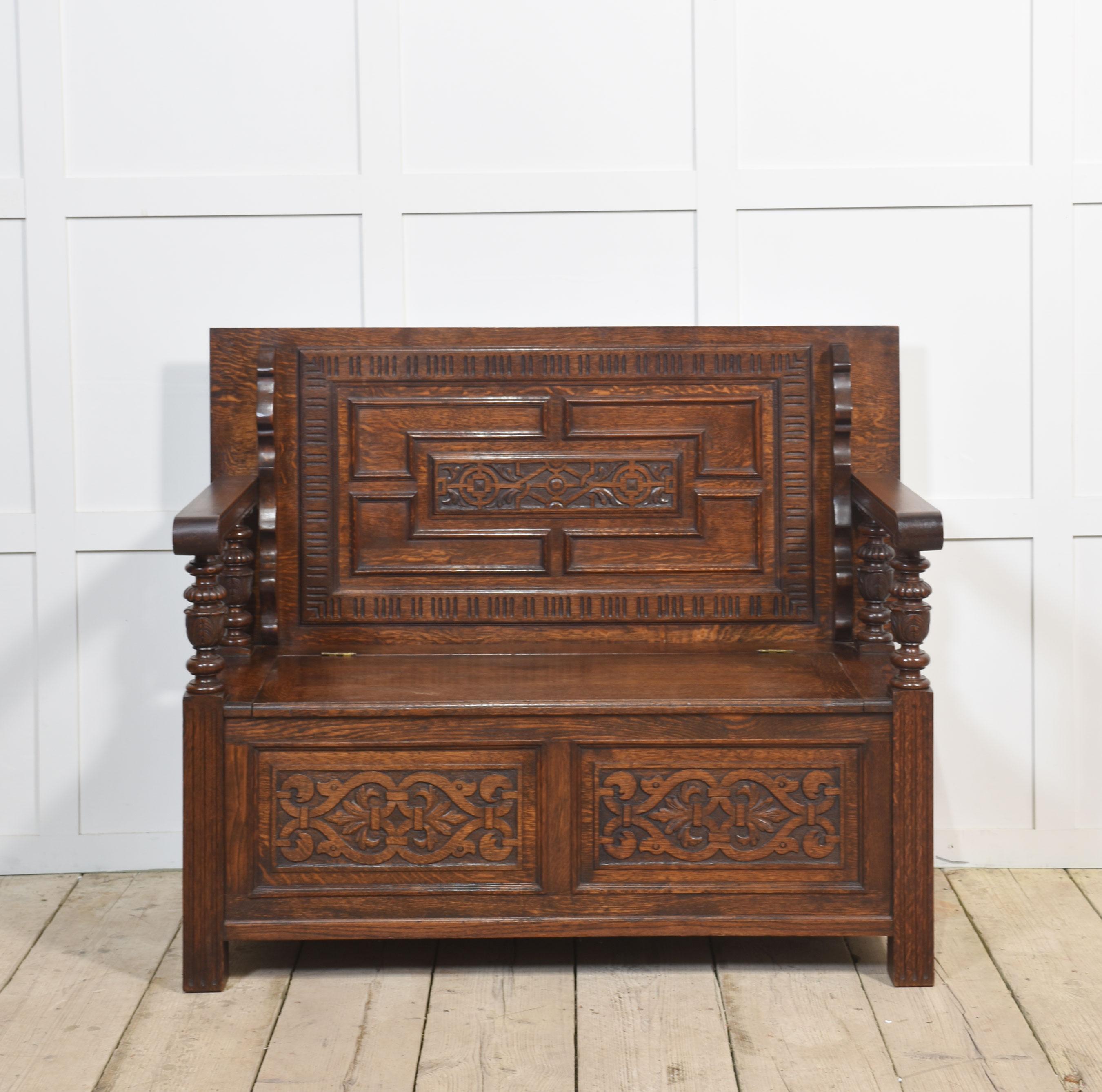 Carved oak monk’s bench/hall bench. The solid oak hinged top with geometric carvings. To the raised scrolling arms with turned uprights. The solid oak seat is hinged and opens to reveal the uninterrupted storage space inside.
Dimensions
Height 39.5