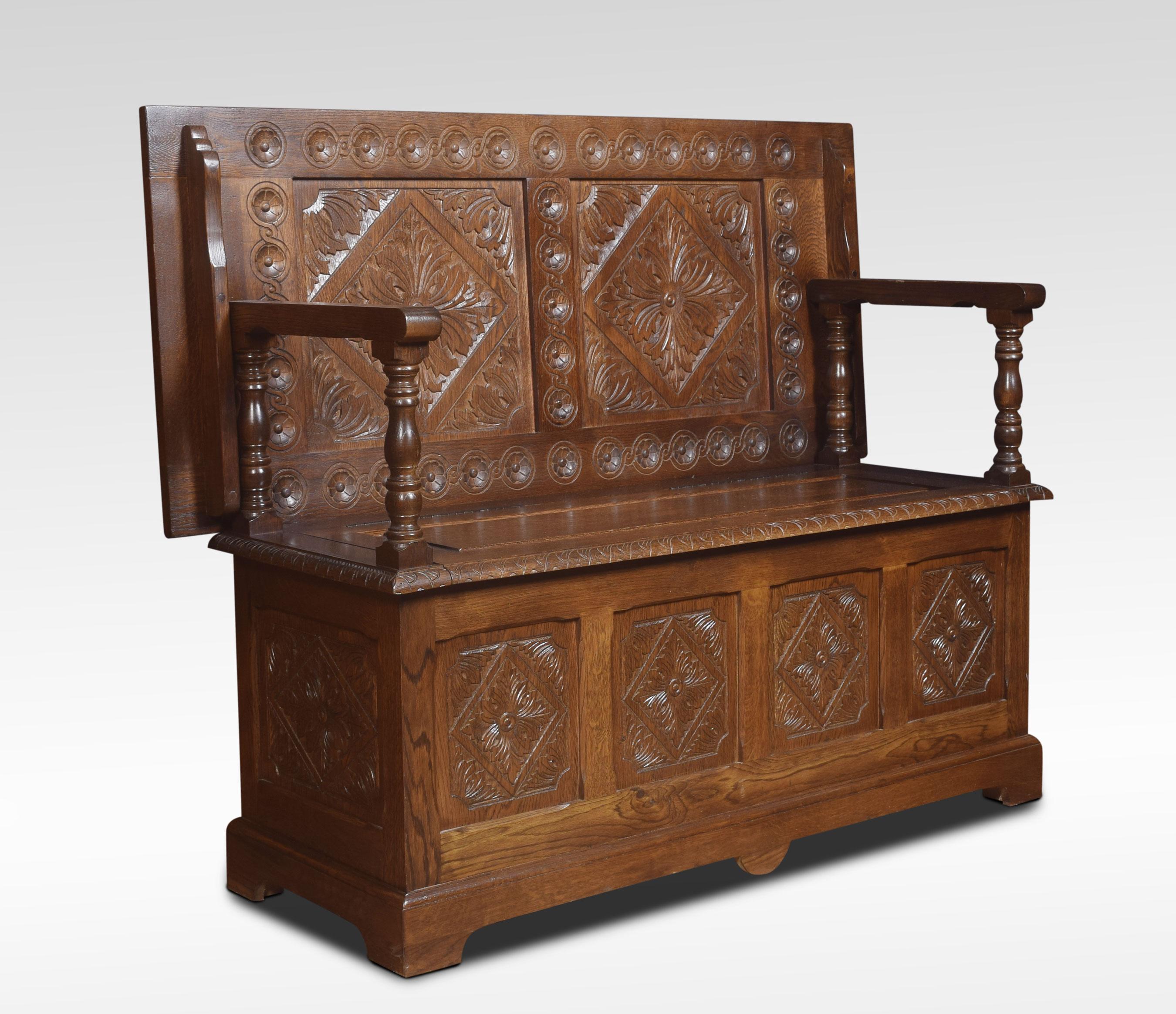 Carved oak monk’s bench/hall bench. The solid oak hinged top with geometric design resting on raised arms with turned uprights. The solid oak seat is hinged and opens to reveal uninterrupted storage space inside.
Dimensions:
Height 39.5 inches