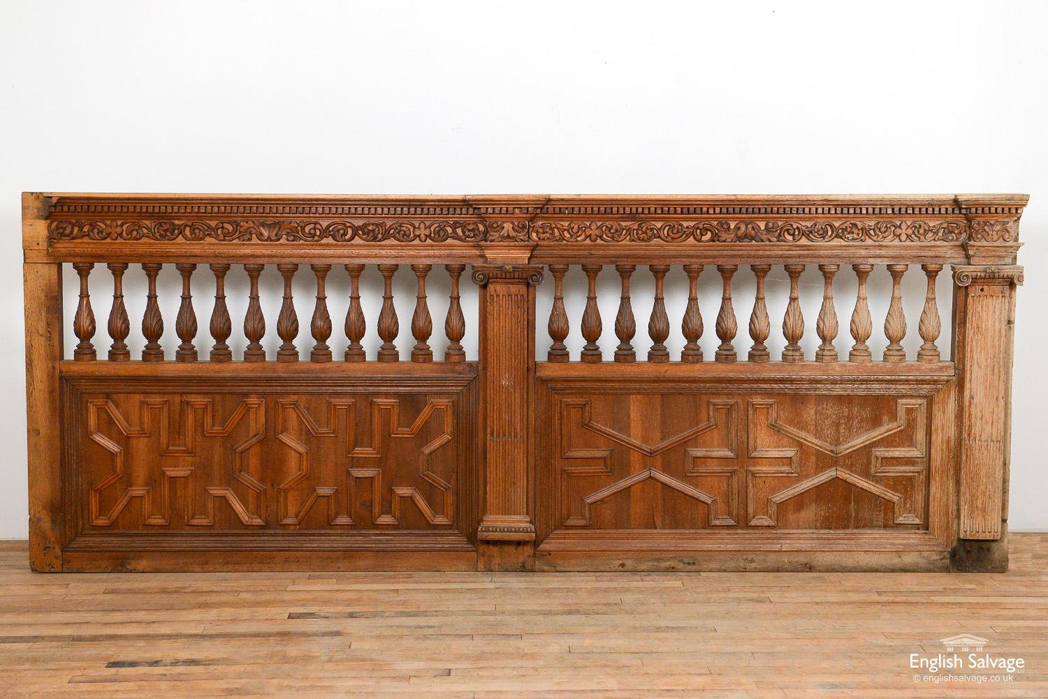 Reclaimed 19th century oak panelling / gallery with integral balustrading. Detail includes a corniced top shelf with dentil layer beneath and carved acanthus leaves layer beneath that. Decorative Ionic style fluted pillars. Fielded decorative panels