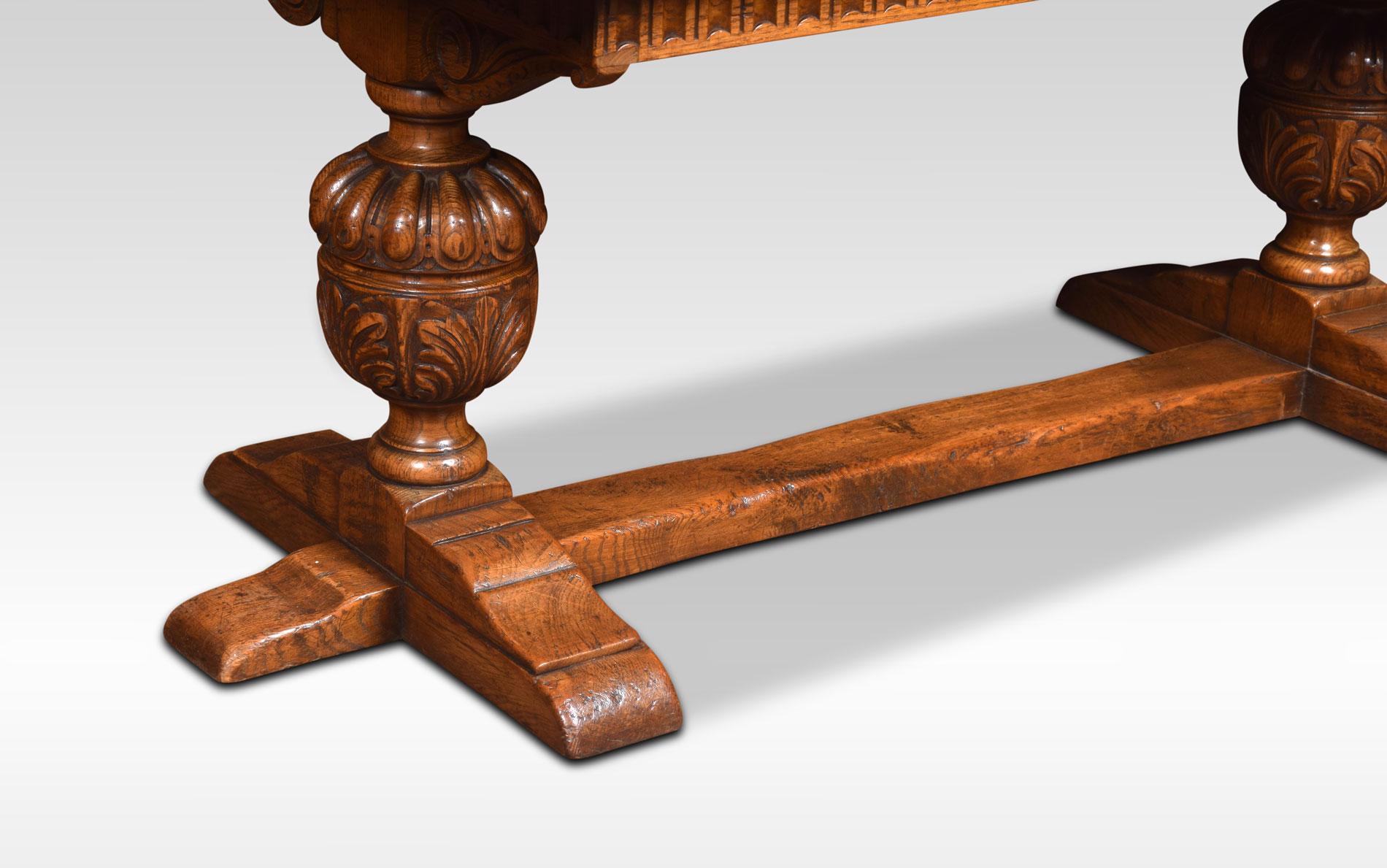 Solid oak refectory table, the rectangular plank top above carved moulded freeze. Raised up on two-lobed and leaf carved cup and cover supports united by a stretcher.
Dimensions:
Height 29.5 inches
Width 66 inches
Depth 33 inches.