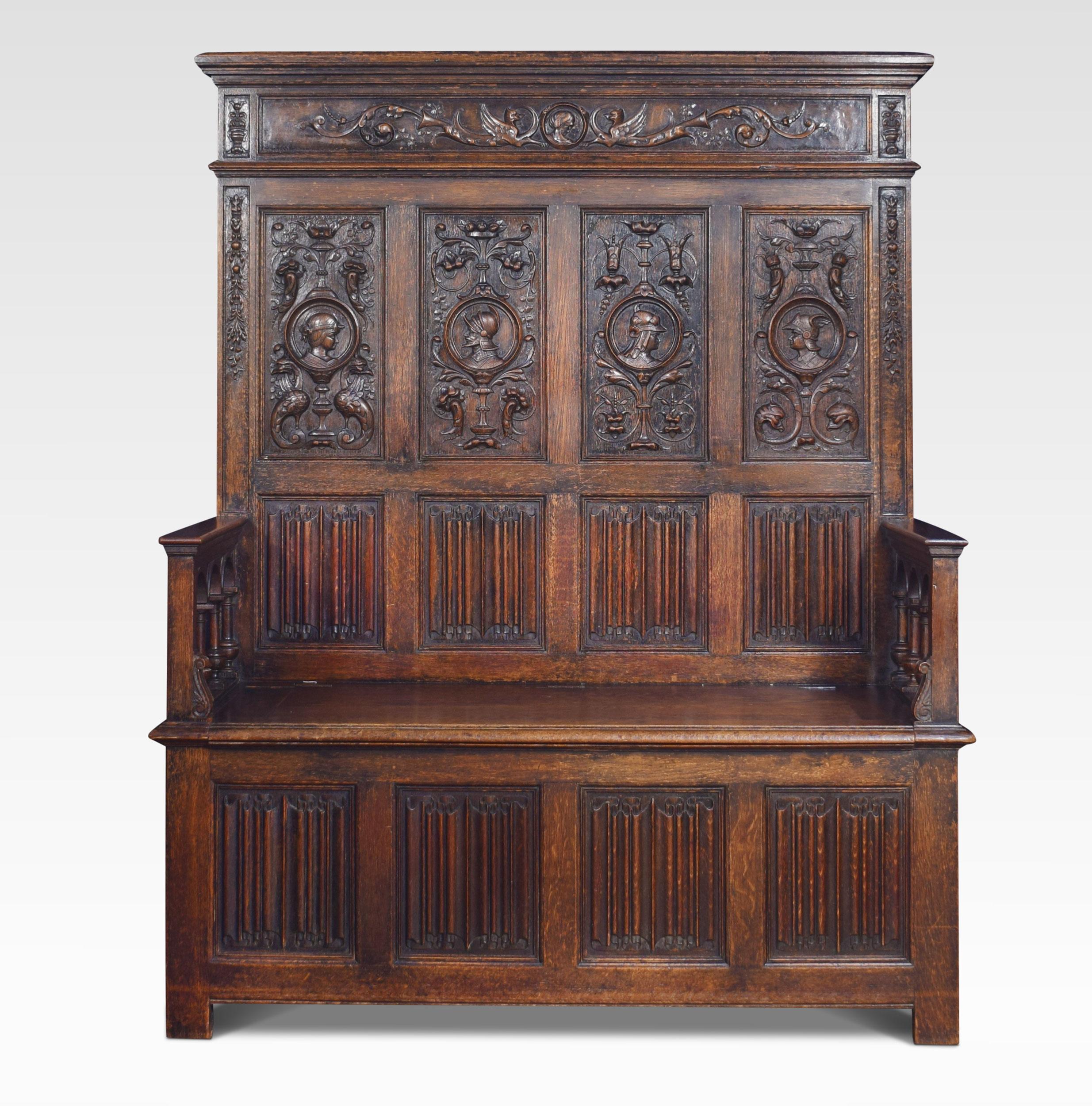 Oak box settle, in the 17th century style, the high back with four panels each centred with a carved knights mask within a moulded roundel, above four linenfold panels, the plain arms raised upon arcaded spindles to the hinged box section and