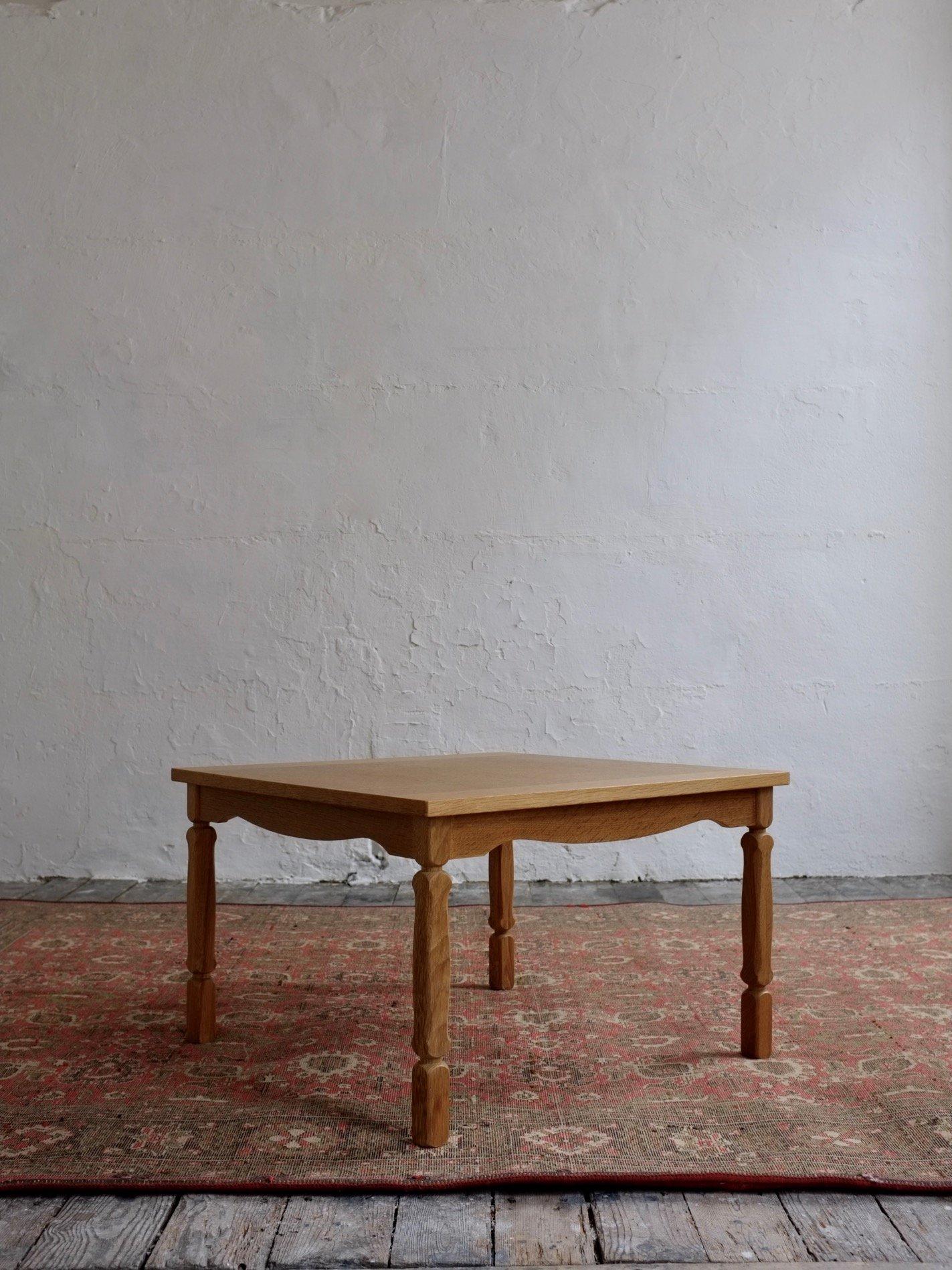 Carved solid oak square coffee table designed by Henning Kjaernulf in the 1950s.  I have several sets of chairs and tables by Henning Kjaernulf, please ask if you’re interested.  You may see the example of a matching design rectangular table in the