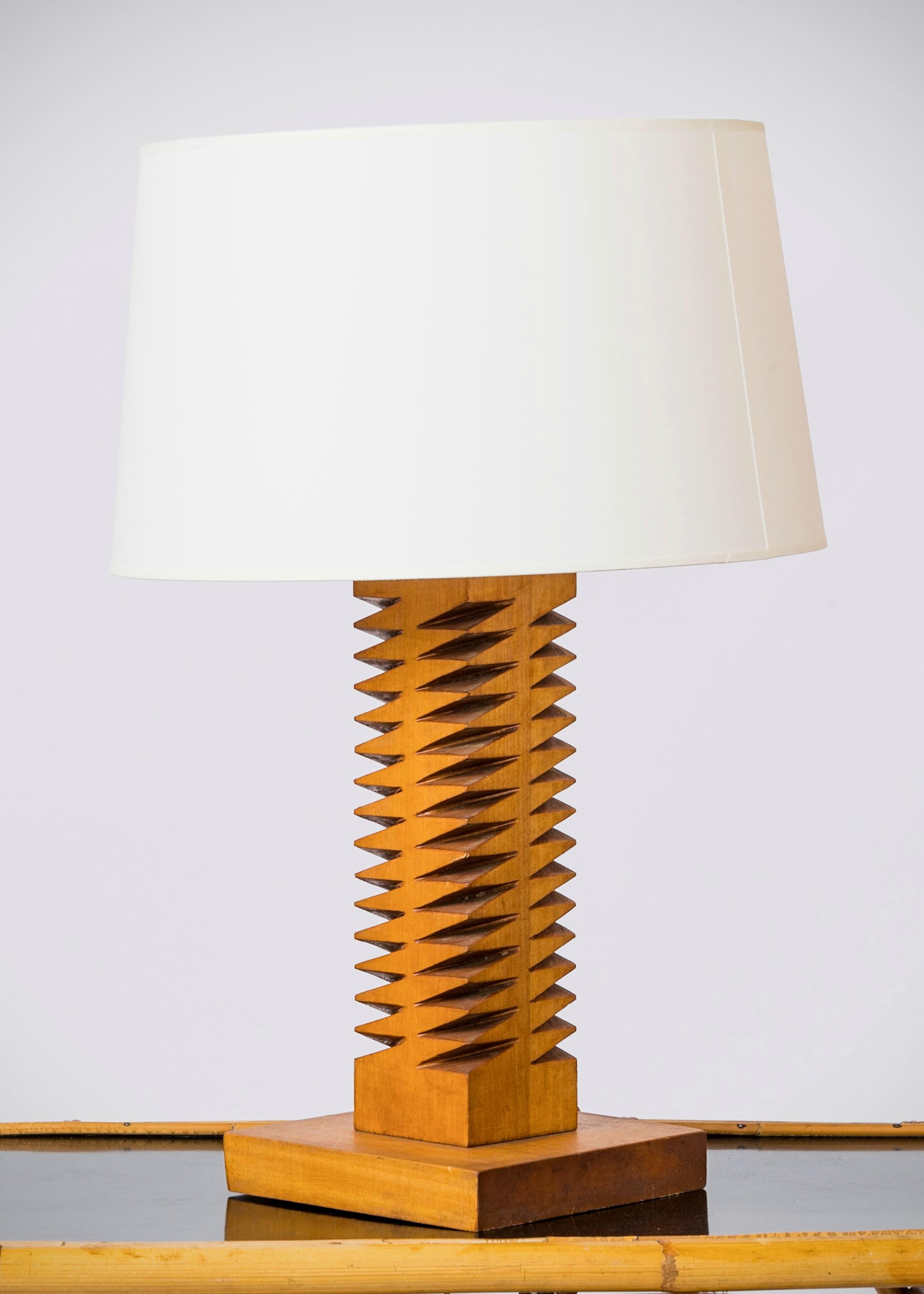 Graphic etched oak table lamp. France 1950s. 
European socket and wiring.
This lamp will ship from France and can be returned to either France or to an upstate NY location. 
Price does not include packing, shipping not possible customs duties