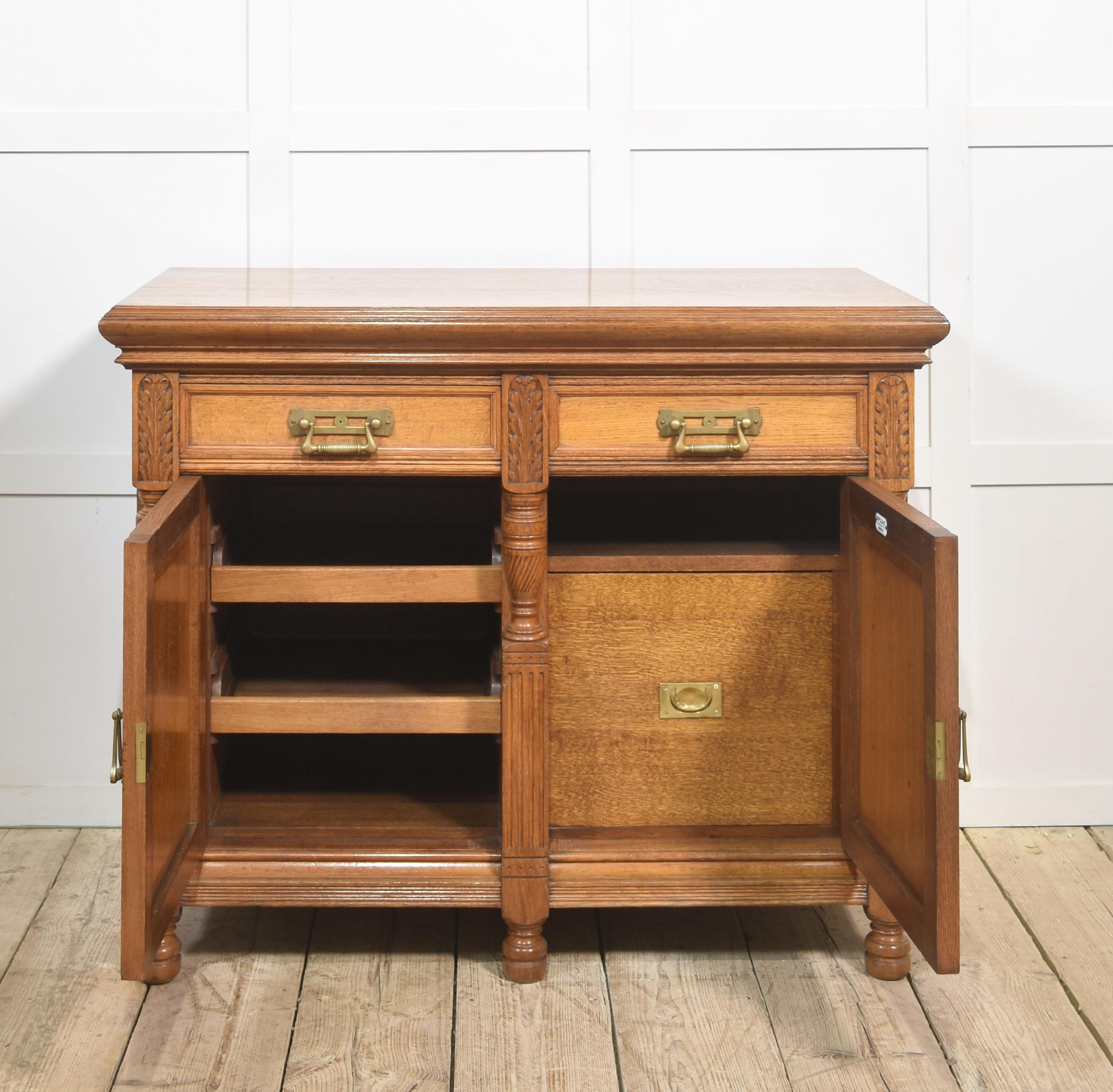 Carved oak two door sideboard by Maple and Co In Good Condition For Sale In Cheshire, GB